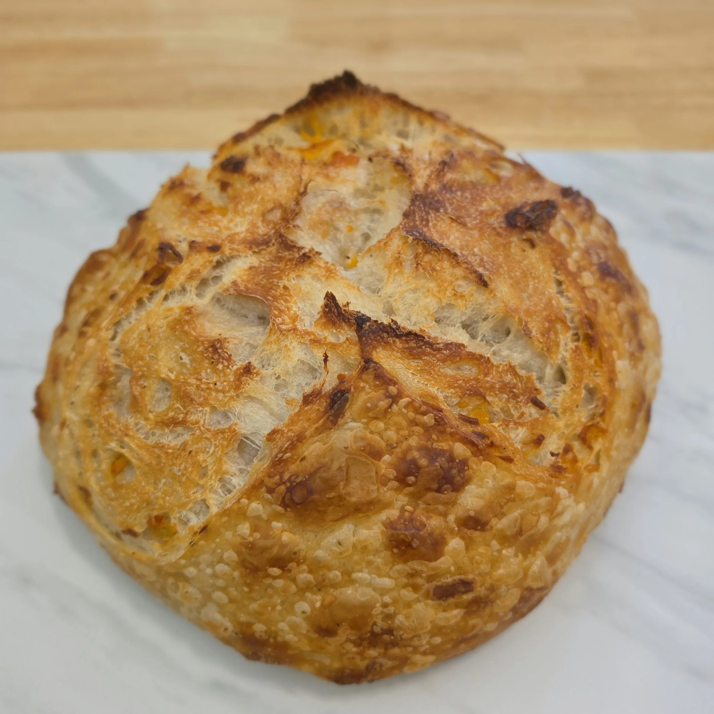 Italian Herb & Cheese: A savory twist on our classic loaf —infused with sharp cheddar and a flavorful blend of Italian herbs.