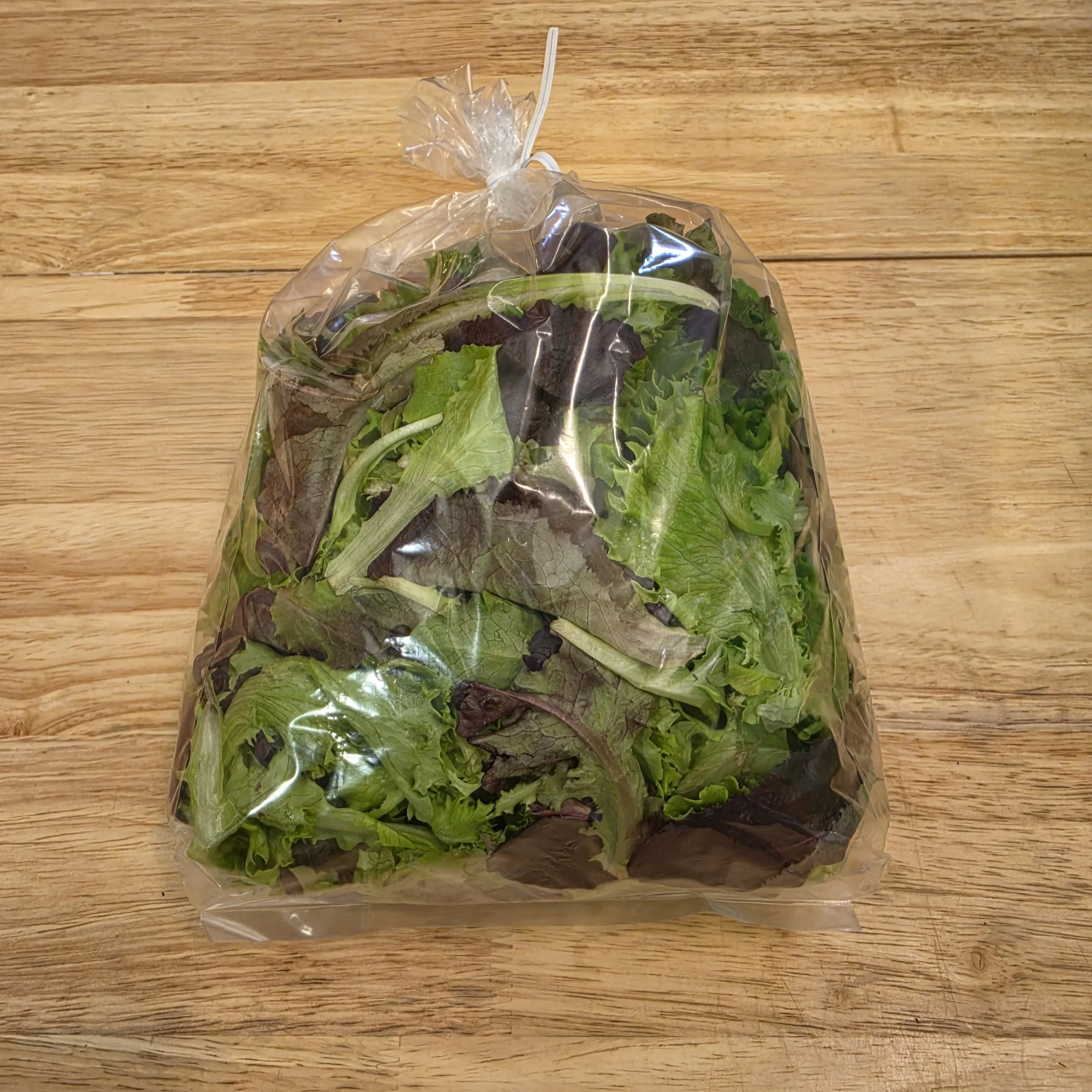 Freshly harvested organic mixed salad greens in a bag from S.J. Organic Farms in Peck, Michigan