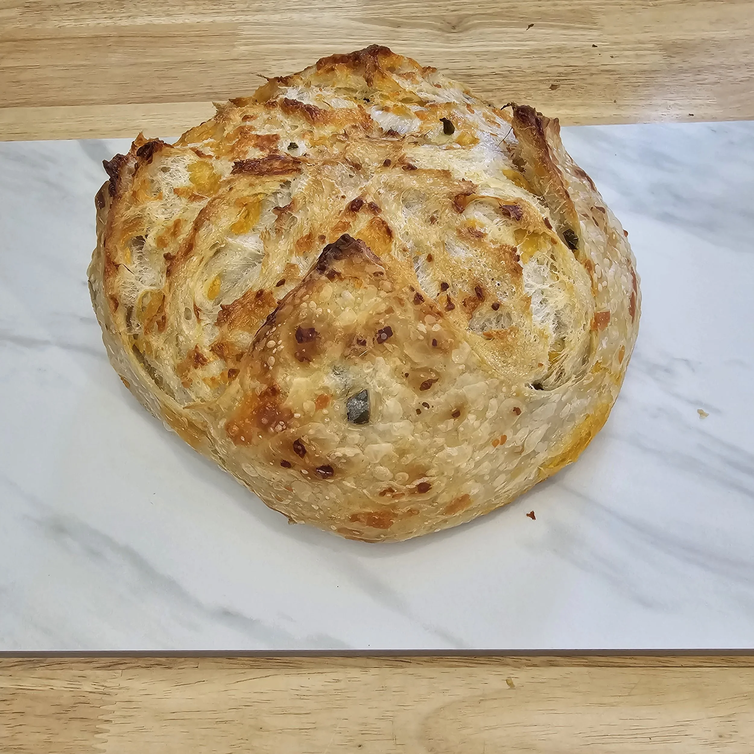 
Jalapeno Cheddar: A crowd favorite — our original sourdough with fresh jalapeños and sharp cheddar for the perfect kick.