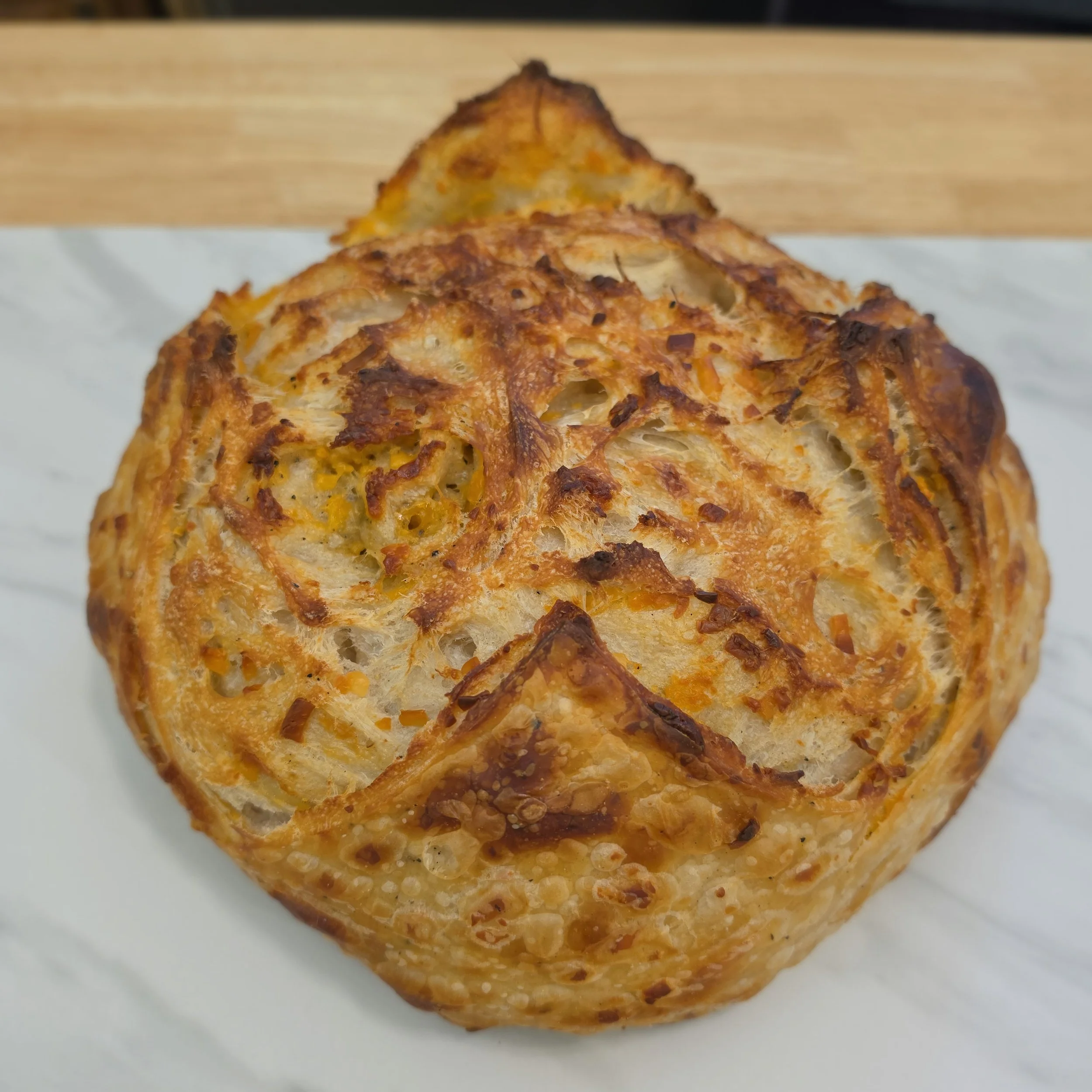 3 Cheese & Pepper: A rich blend of cheddar, asiago, and gruyère with a hint of black pepper for a bold, cheesy twist on our classic sourdough.