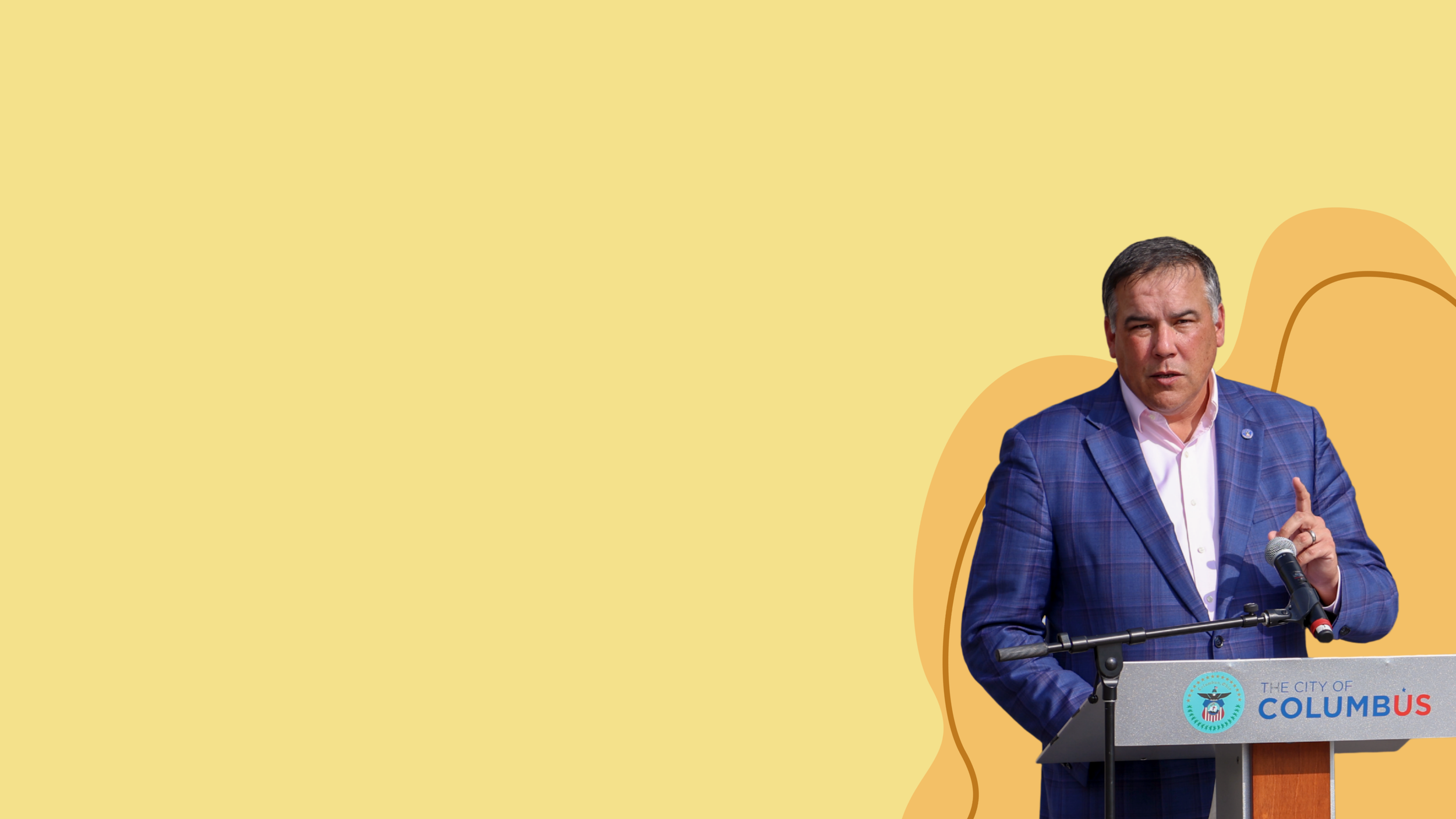 Image of Mayor Andrew Ginther Speaking at a podium with a yellow backgound