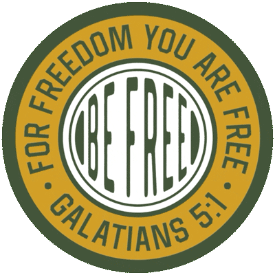 Circular emblem with the words "BE FREE" in the center, surrounded by a ring with the phrase "FOR FREEDOM YOU ARE FREE" and a biblical reference to Galatians 5:1