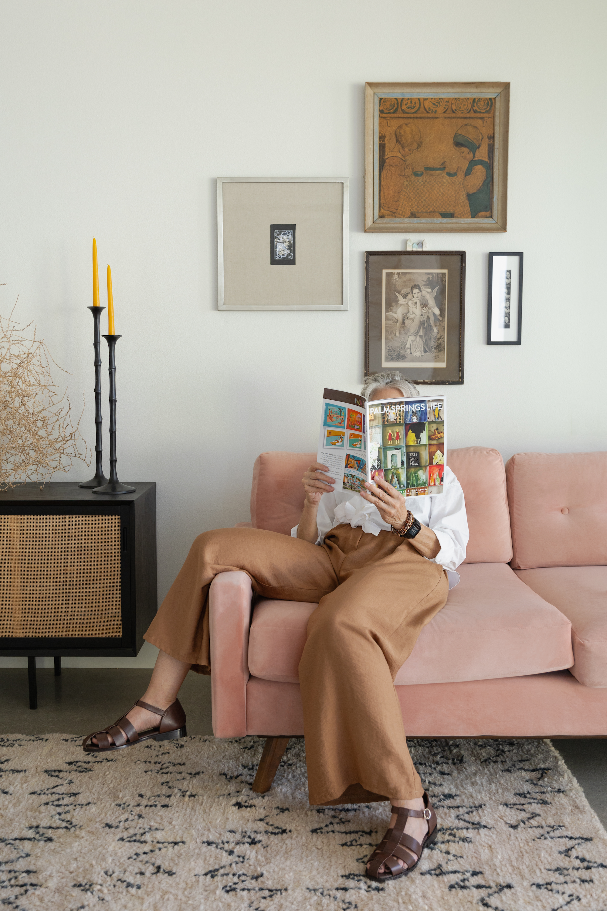 Julie Colbrese siting on a couch reading a magazine