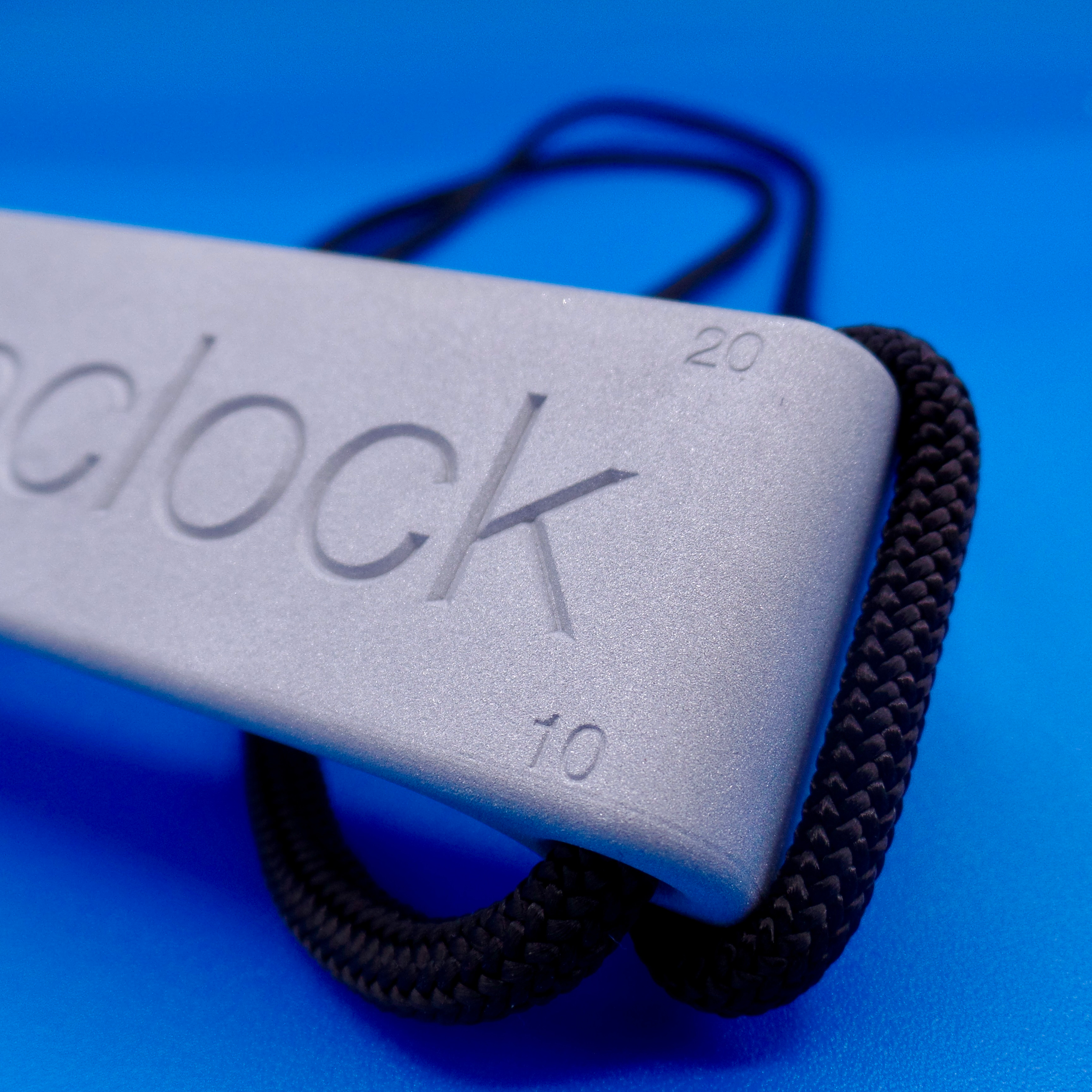 Close up of the 12:8 block on a blue background, zooming in on the engraving on the back of the product.