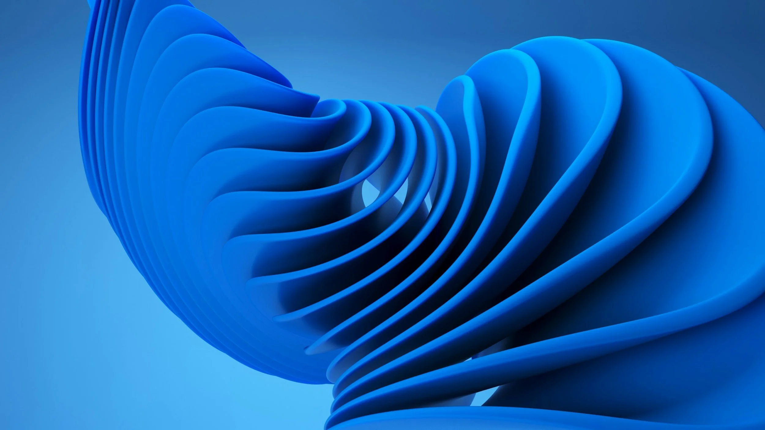 Close-up of an abstract blue sculpture with layered, curved shapes.