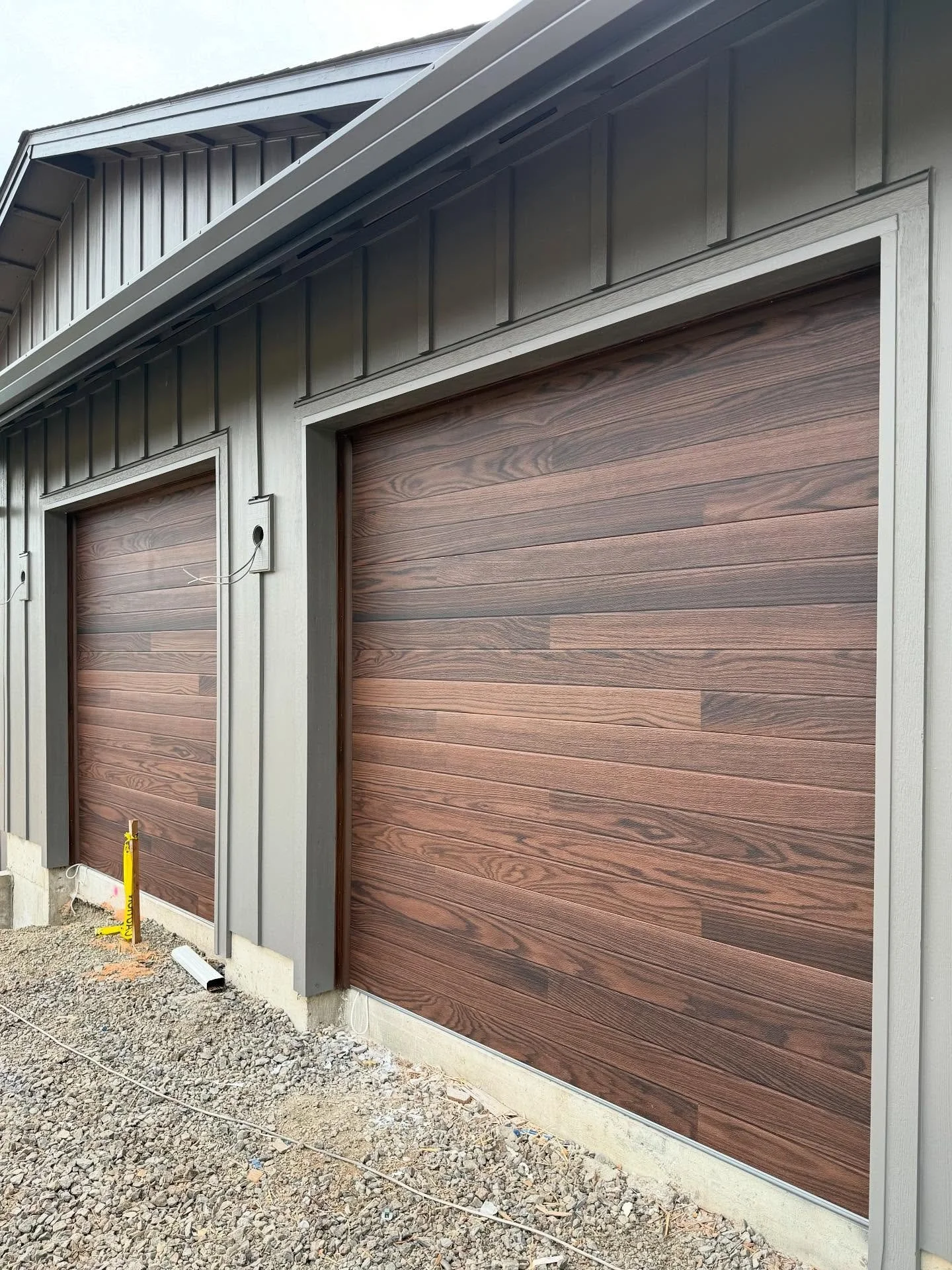Don&rsquo;t overlook the impact the garage door has on your curb appeal&mdash;especially when you&rsquo;ve got an oversized 3-car side-load that meets you at the end of the drive. From @chioverheaddoors Planks Collection, the Dark Oak &ldquo;woodtone