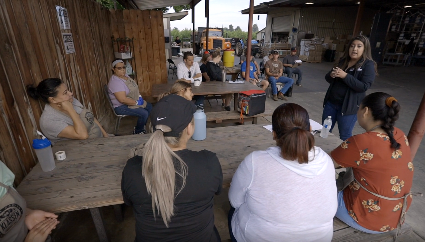 GAR trainer leading an on-site Worker Protection Standard training session with a grower's crew