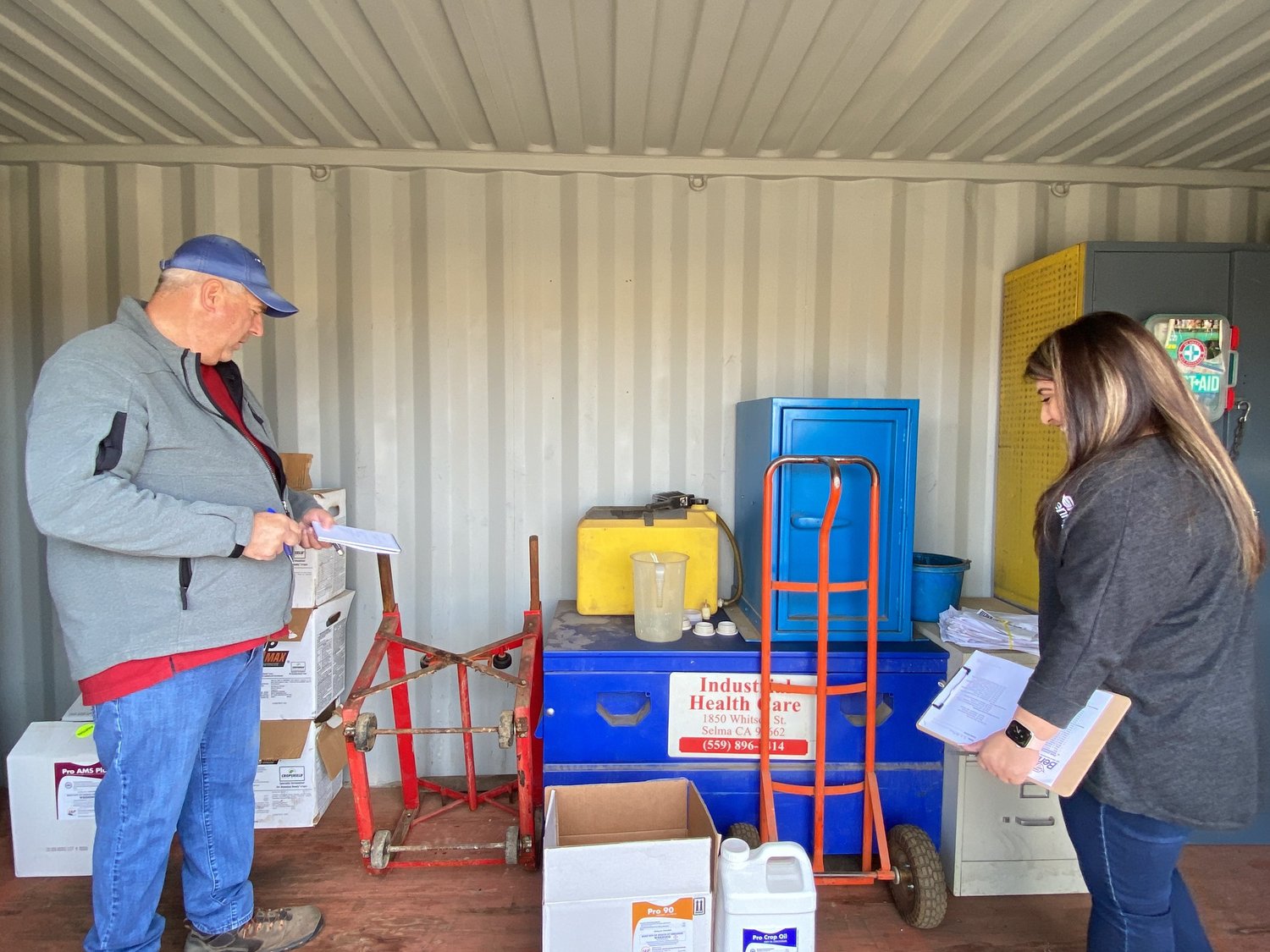GAR staff reviewing pesticide safety equipment and compliance paperwork on-site