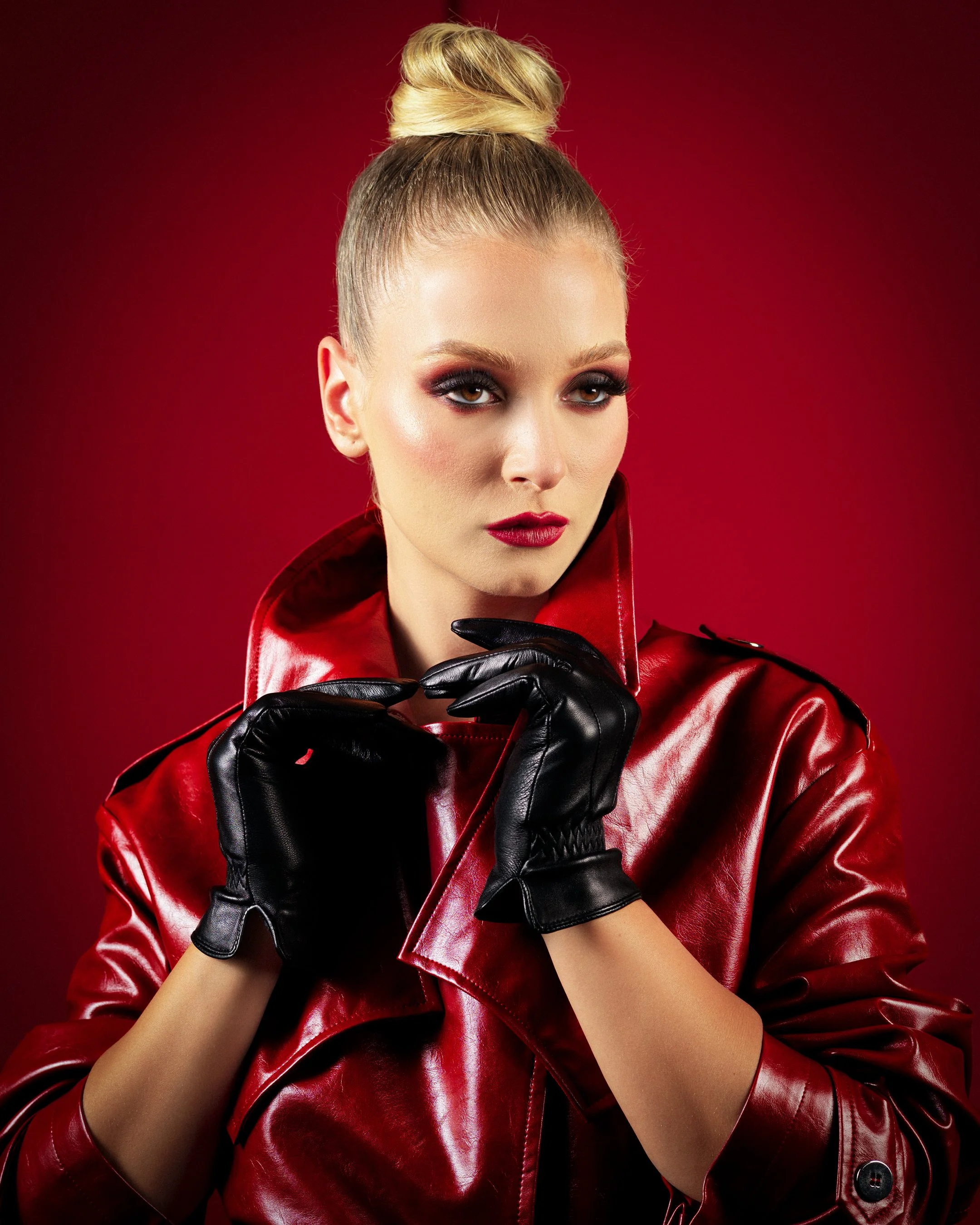 crimson authority fashion editorial by Peter lovit beauty shot red trench coat black gloves crimson backdrop 