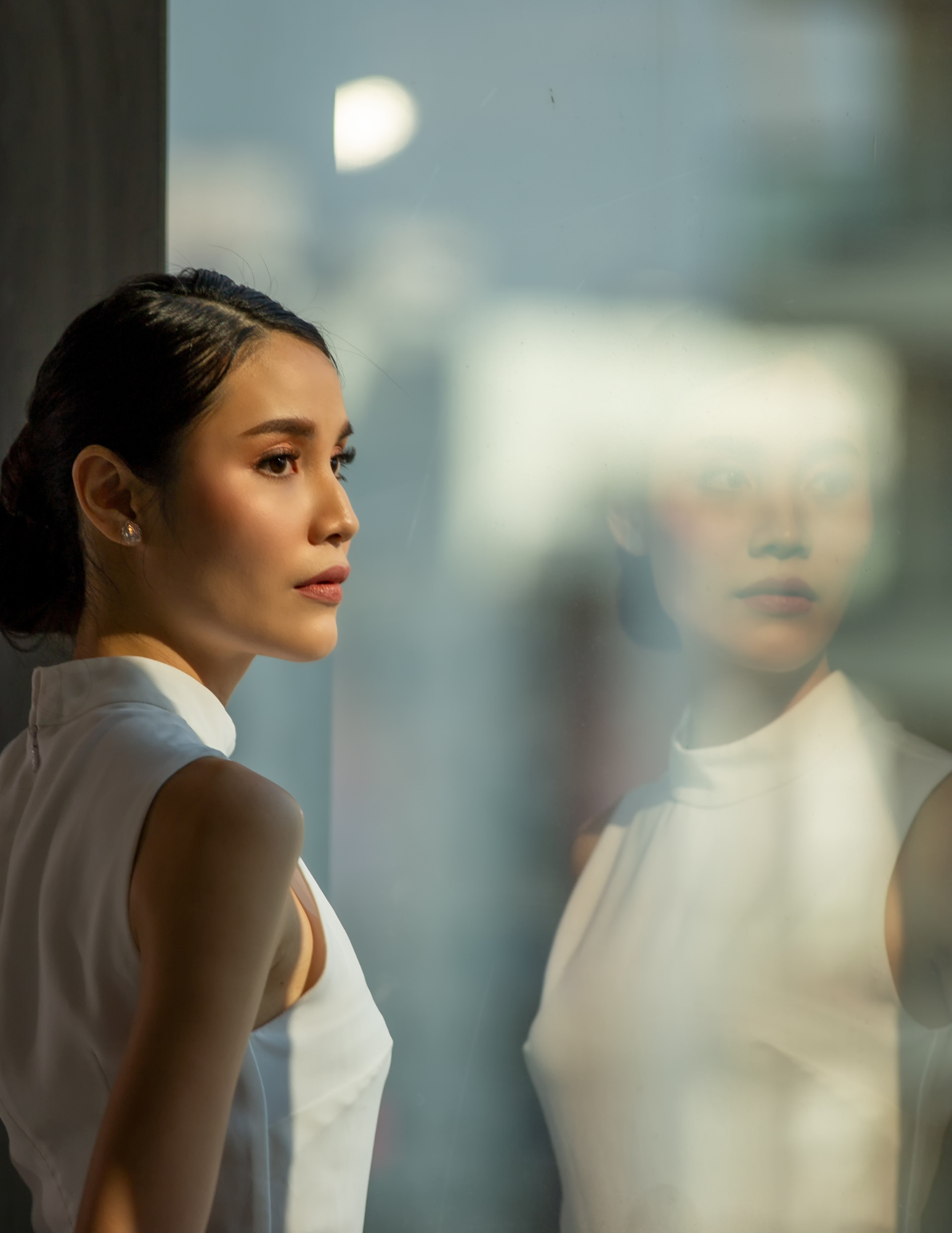 Woman sitting quietly in reflection after an emotionally difficult conversation, representing emotional triggers and self-awareness.