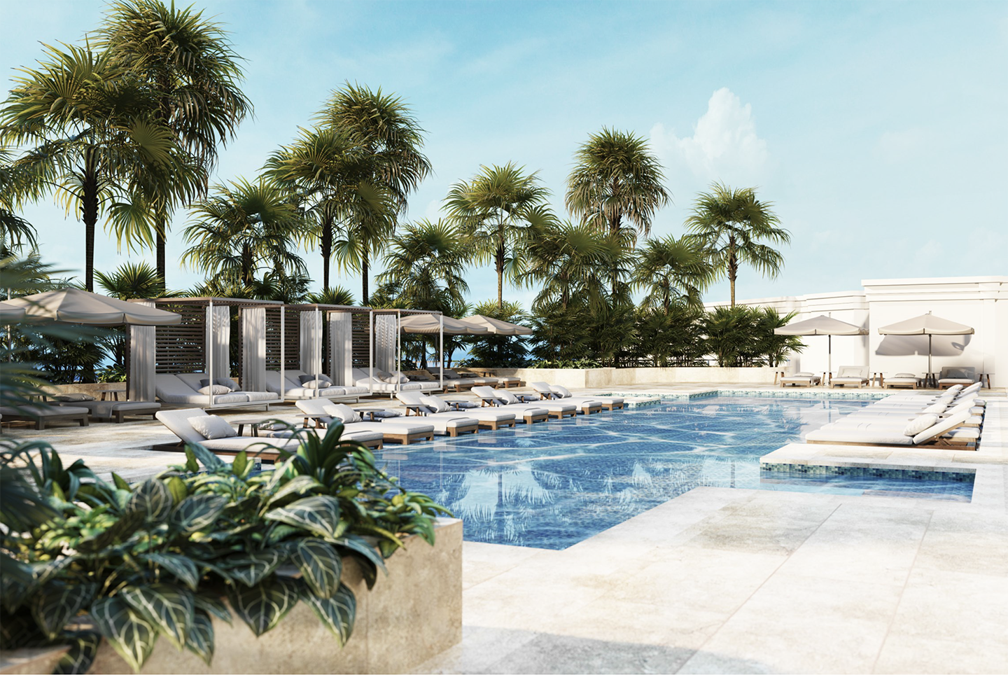 Luxury rooftop pool area with lounge chairs, umbrellas, tiki huts, tropical plants, and palm trees under a clear sky.