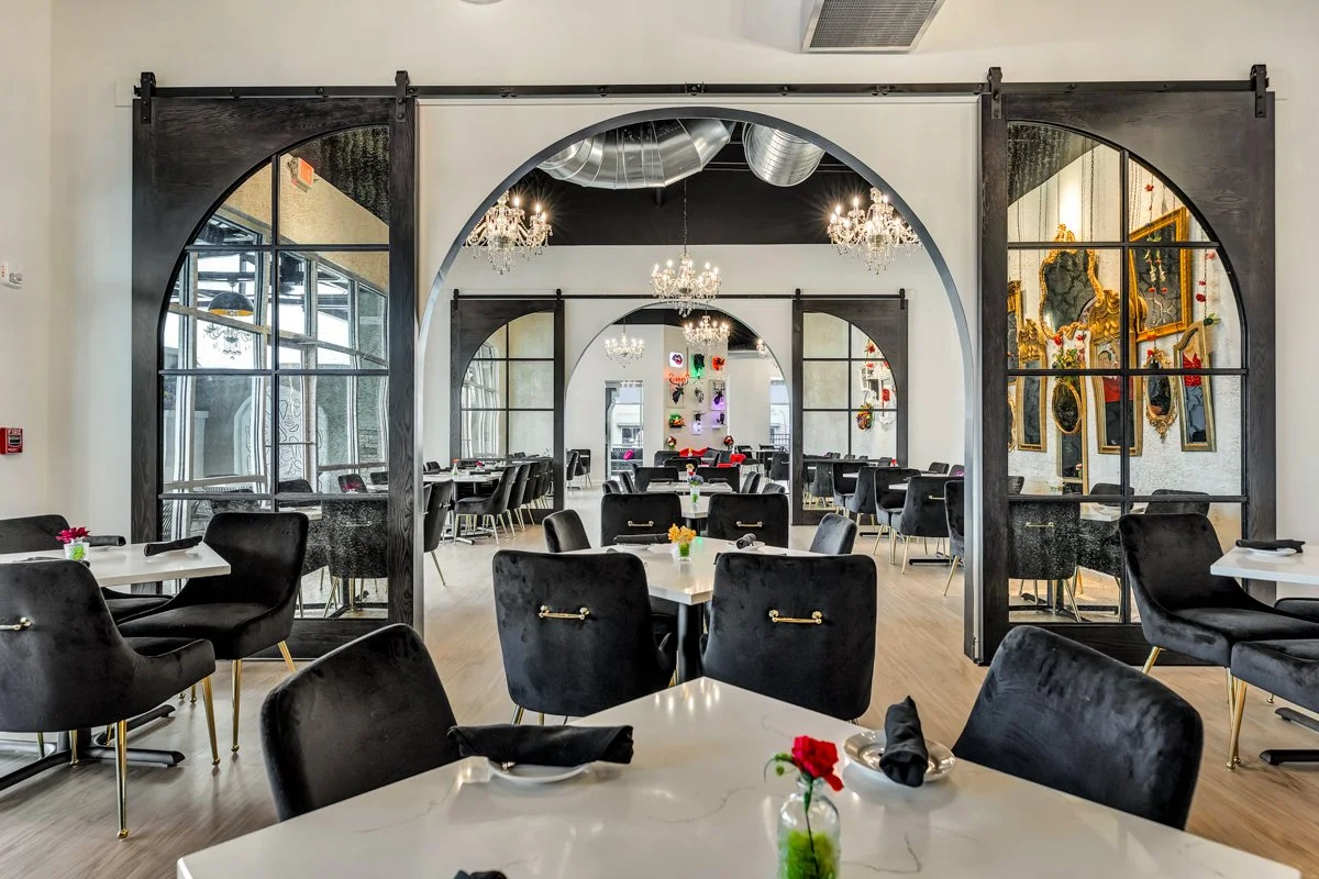 Indoor dining area - Black velvet chairs and large arch mirrored doors