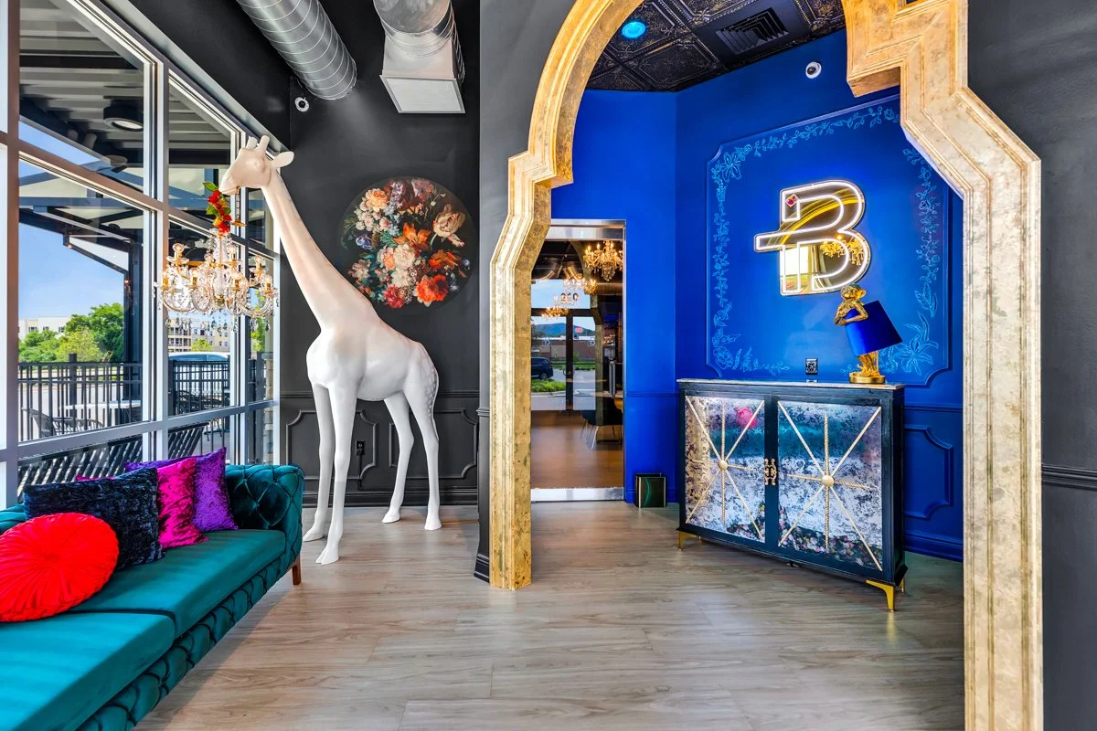 Entry way with bold blues and gold details! And a standing giraffe floor lamp chandelier
