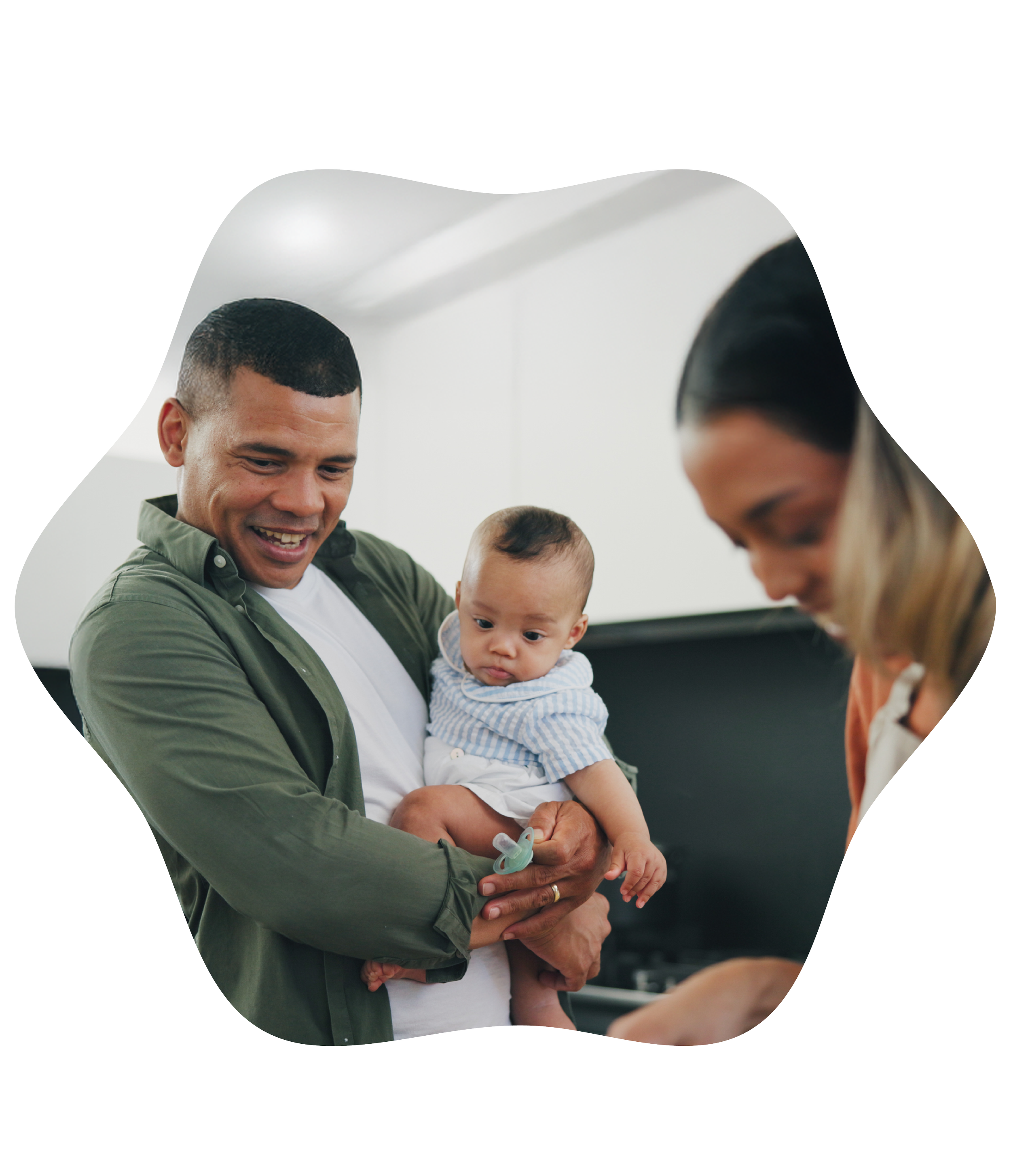 Parent holding their baby while a doula offers guidance and reassurance.