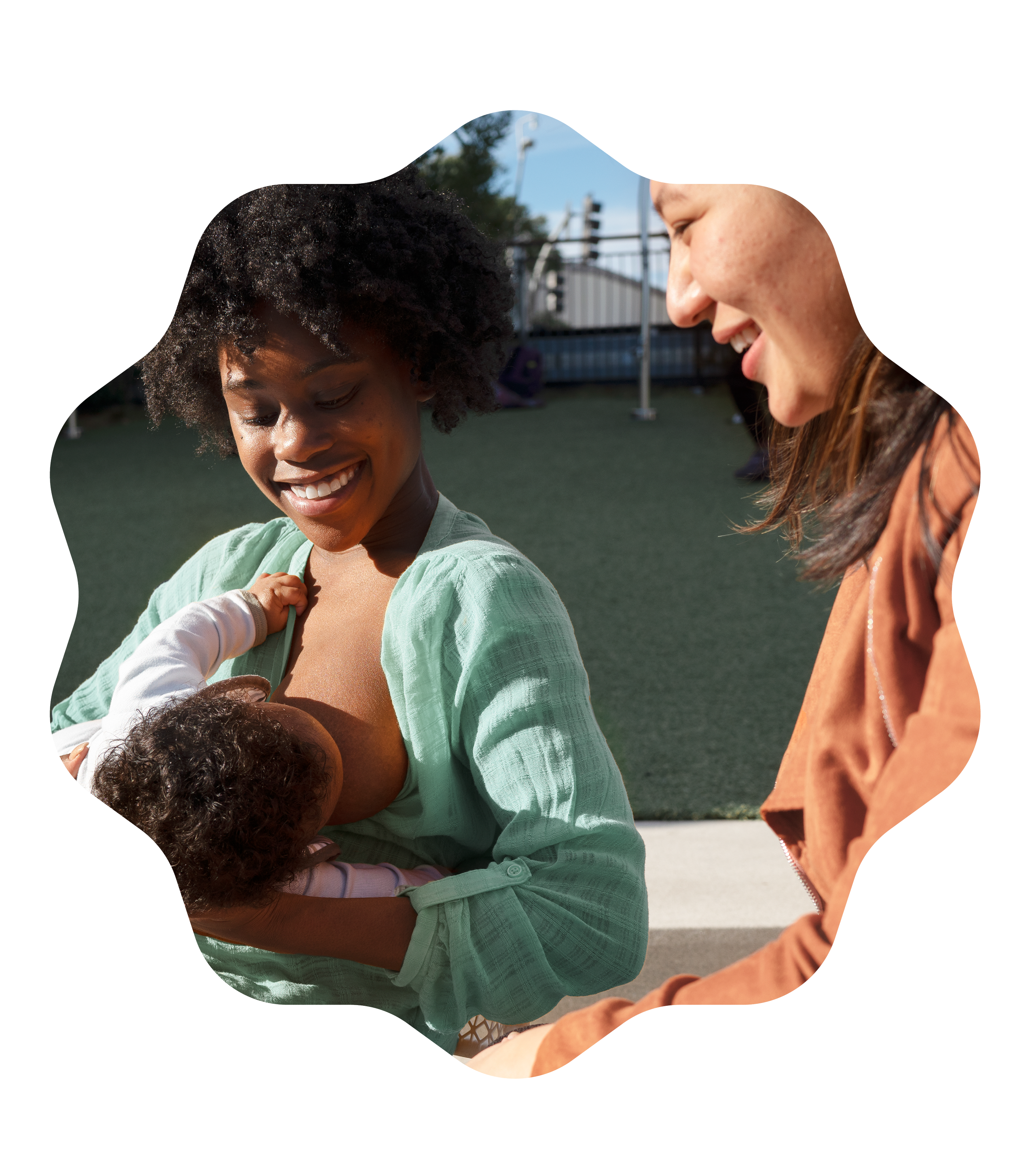 Parent breastfeeding their baby with a doula offering hands-on support.