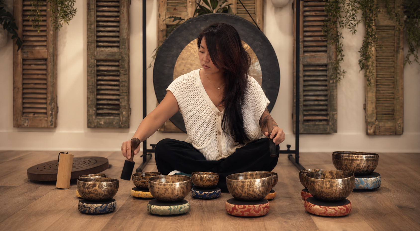 Arum Son founder of Madam Soul Pull in a sound meditation with Himalayan singing bowls