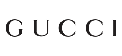 Close-up of the Gucci logo on a black background.