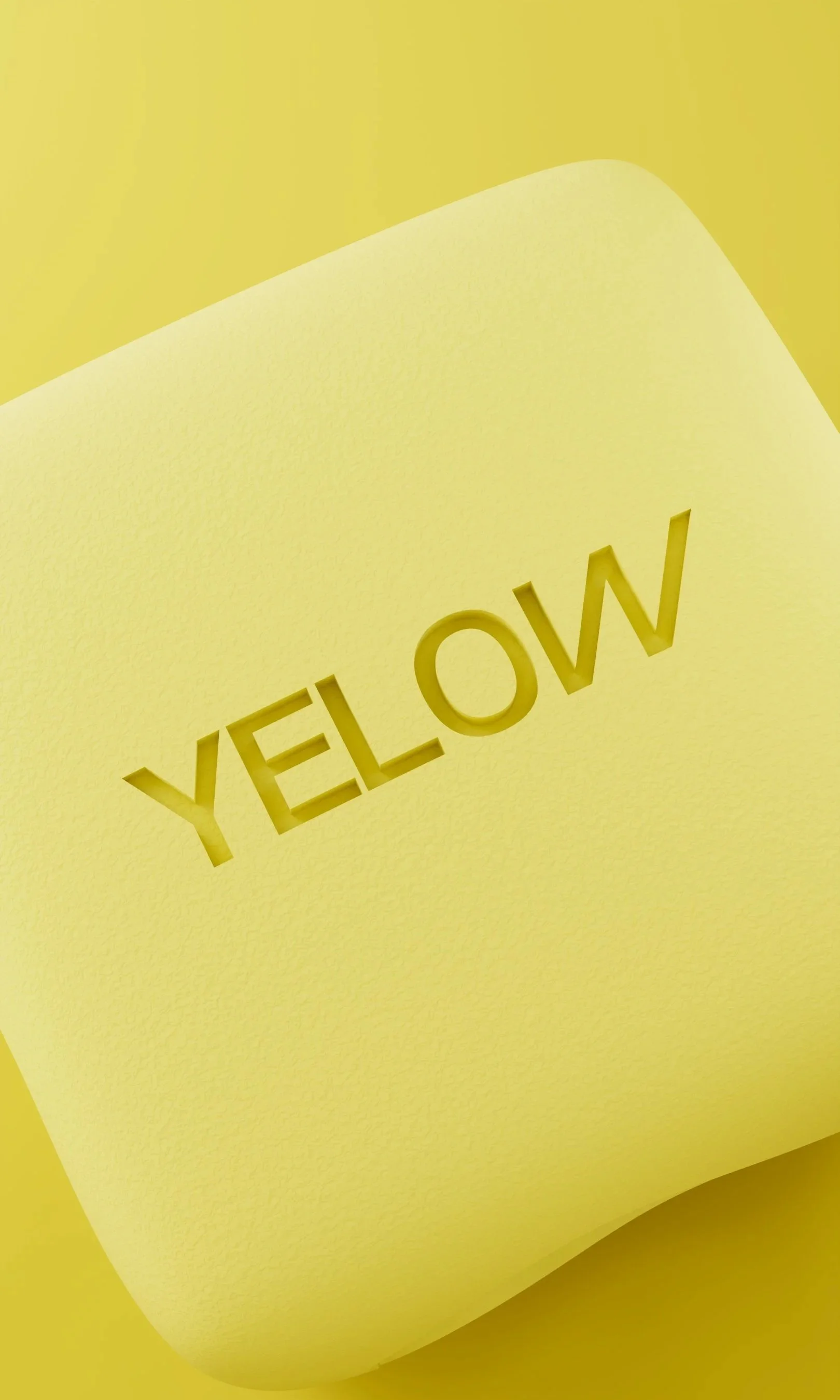 A yellow cube with the word 'YELLOW' cut out in the center.