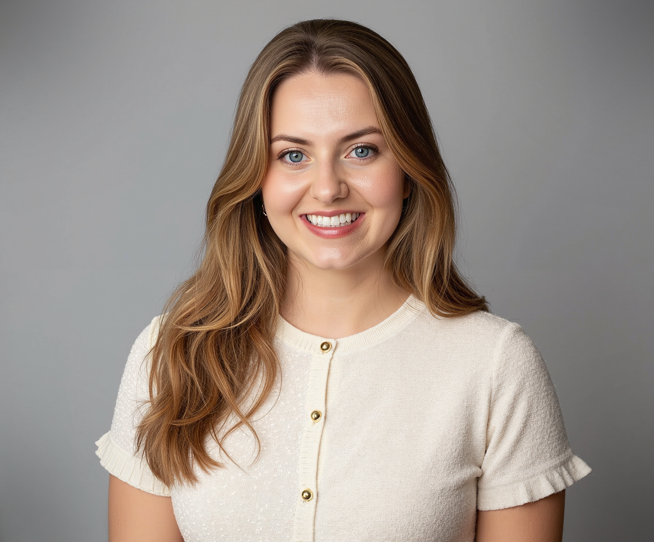 Abby Bacardi Ellis, a woman with long hair and blue eyes, smiles warmly at the camera.