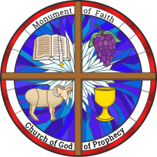 A circular stain glass window divided into four sections, with symbols representing the Monument of Faith, Church of God, and Gospel. Shows an open Bible, a bunch of grapes, a sheep, and a chalice, with text around the border.