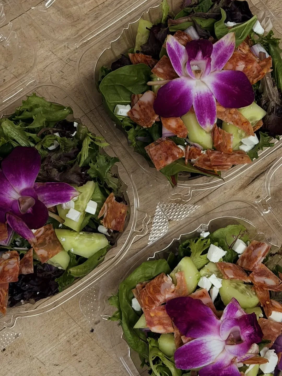 NEW side salads by our produce manager, inspired by our staff member Alex. 
🎉 Alex's Bloom Bowl has Organic spring mix, organic cucumbers, organic local red onion, Lively Run feta, soppressata salami, and an edible orchid! 

#potsdam_food_coop #sala