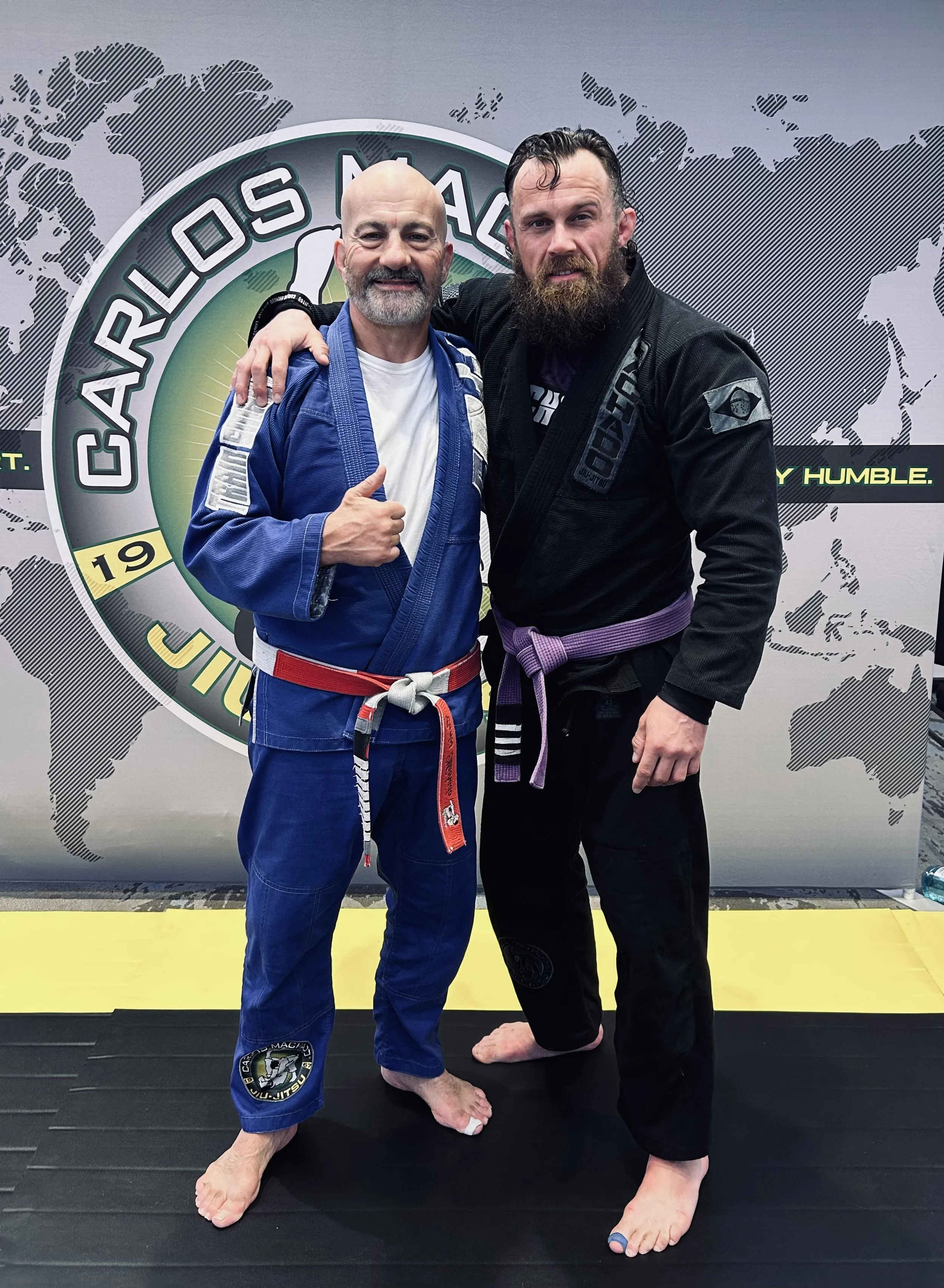 Dustan McKinnon and Carlos Machado in their gi at the Machado Method Summit