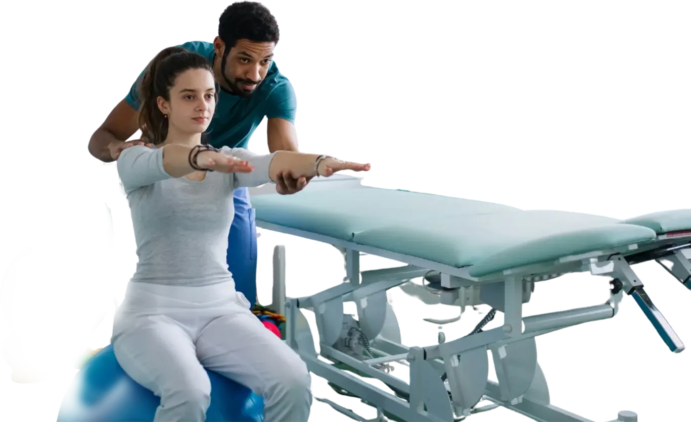 A woman performs physical therapy exercises on a therapy table with a therapist assisting her by guiding her arm movements.