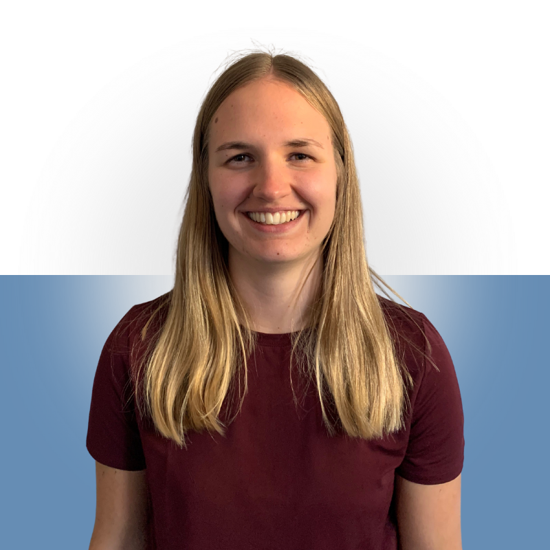 A young woman with long blonde hair, wearing a maroon shirt, smiling against a background split into white and blue sections.