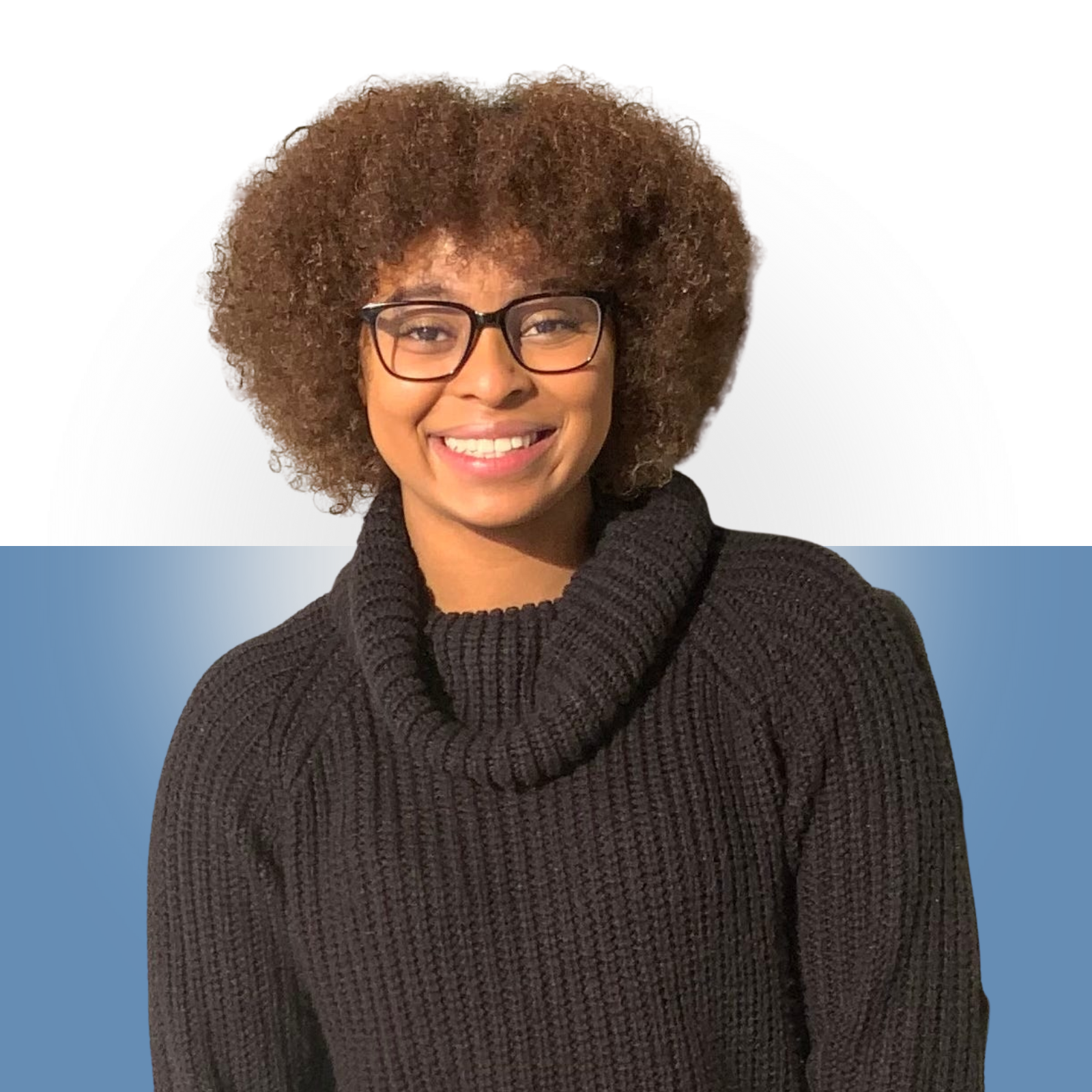 Smiling woman with glasses wearing a black turtleneck sweater, standing in front of a background with white and blue sections.