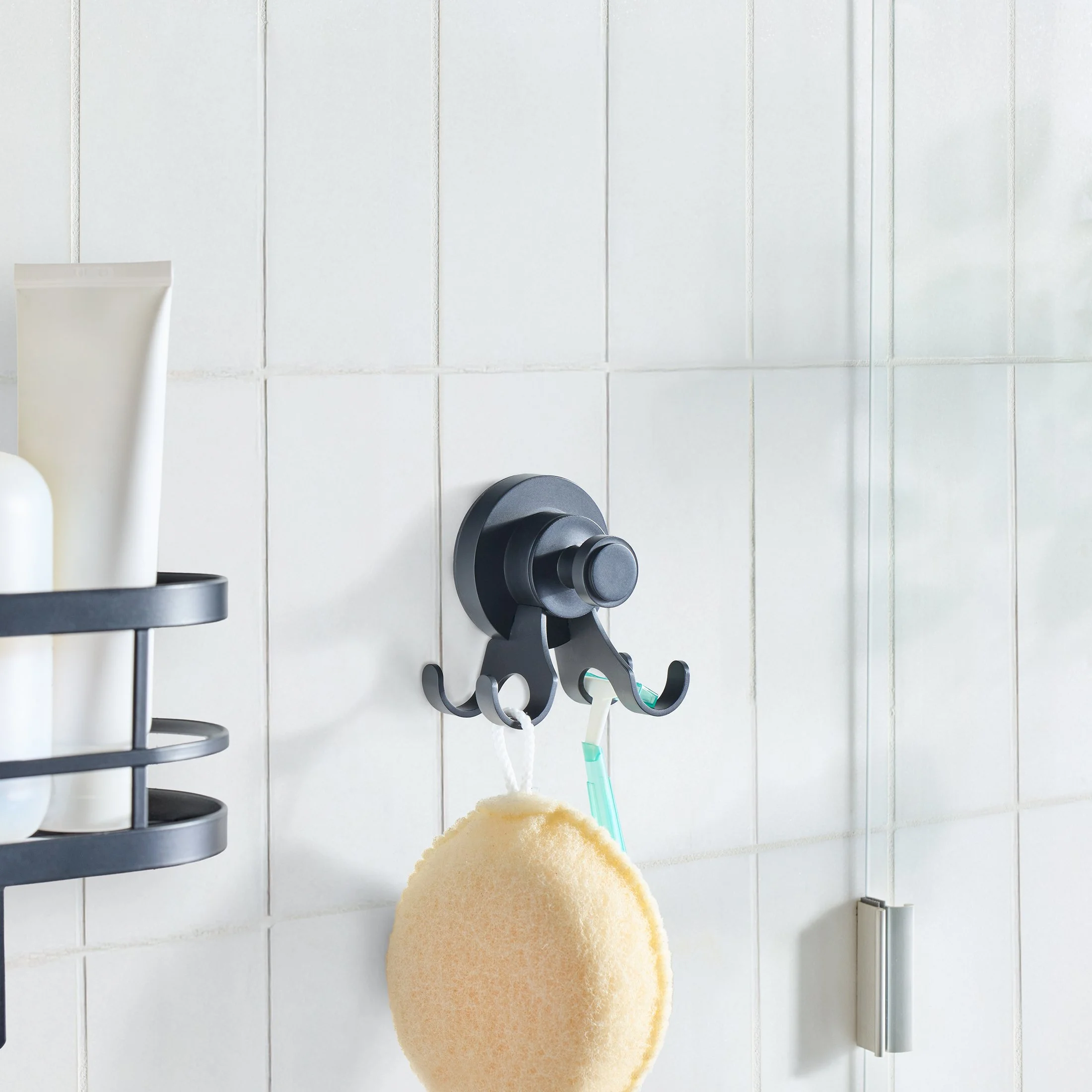 StyleGrip black multi-hook shower accessory holding a loofah and razor