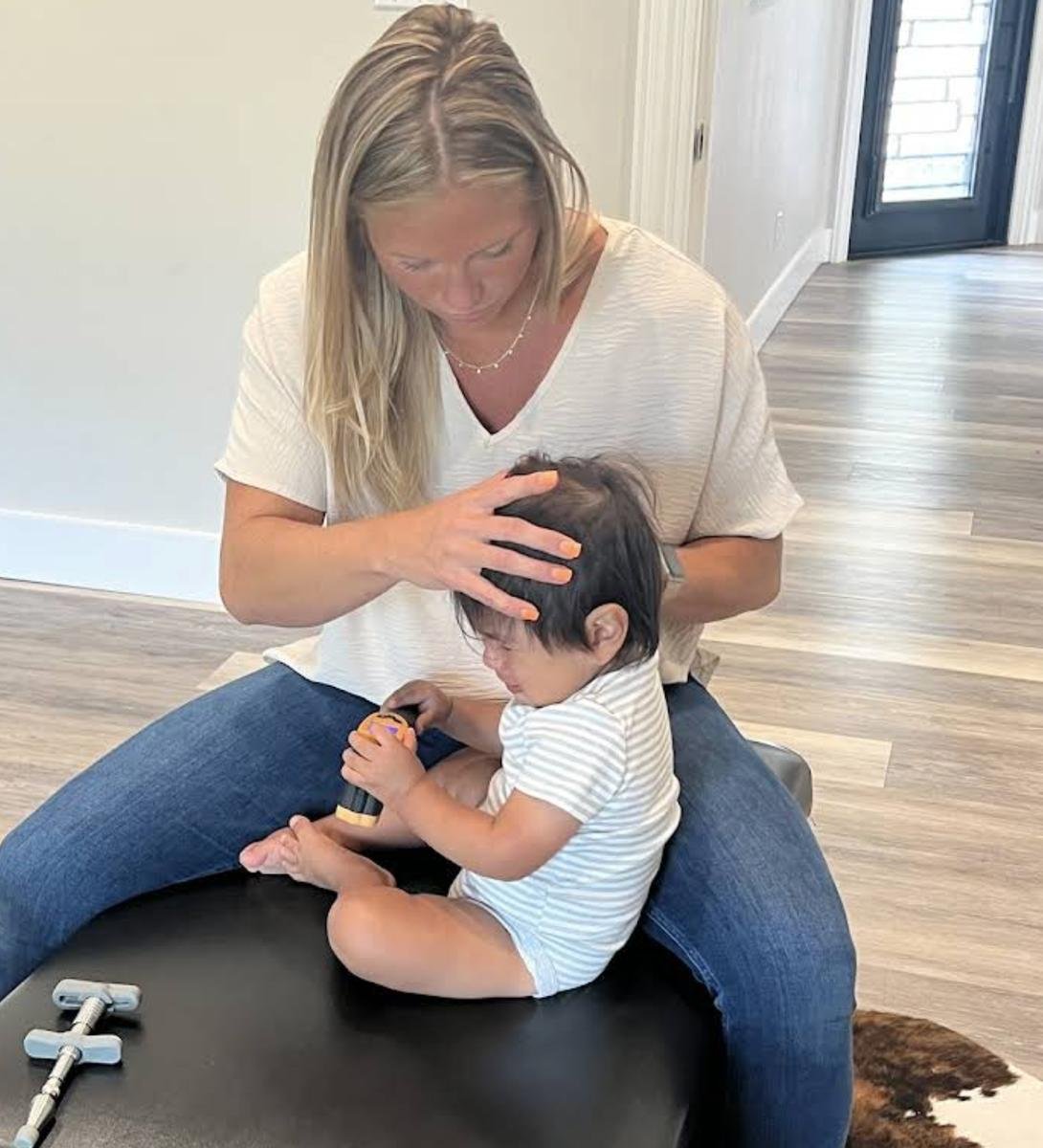 Dr. Kara Rodriguez providing playful, gentle pediatric chiropractic care for sensory processing at Social House Chiropractic in Prosper, TX.