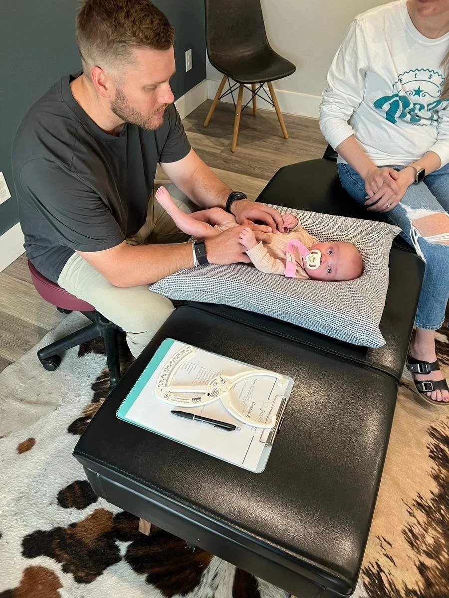 Dr. Collin Walding providing colic relief for infants using CLA INSiGHT neurological scanning at Social House Chiropractic in Prosper, TX. Drug-free colic and reflux support.