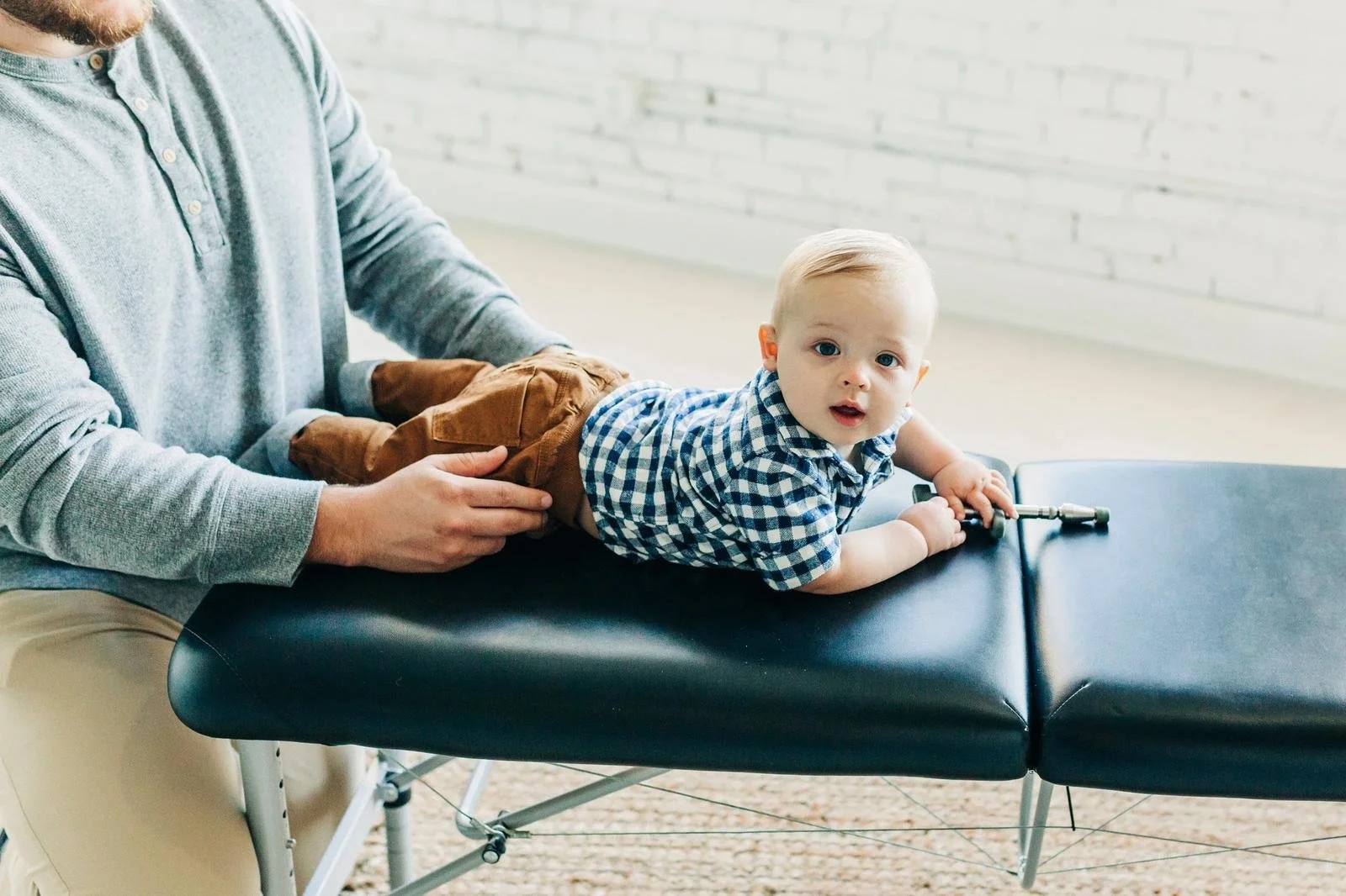 Dad with baby at Social House Chiropractic in Prosper, TX