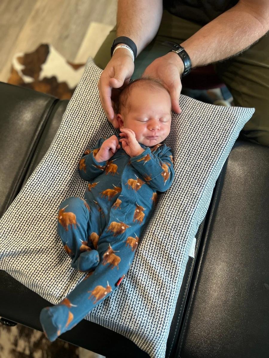 Gentle newborn chiropractic care for torticollis at Social House Chiropractic in Prosper, TX. Sleeping baby — no more pressure than checking a ripe avocado.