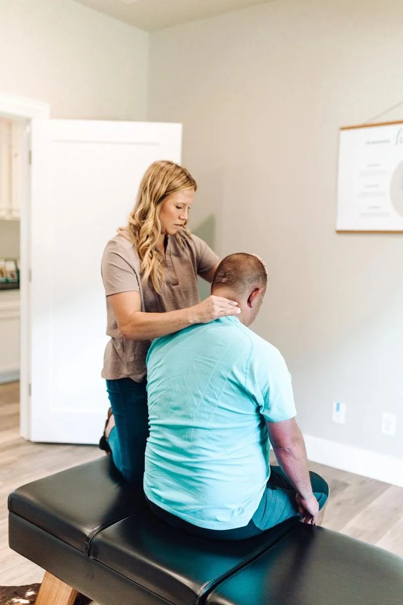 Dr. Kara Rodriguez performing a thoracic adjustment for adult back pain at Social House Chiropractic in Prosper, TX. Neurologically-focused chiropractic care for chronic and acute back pain.