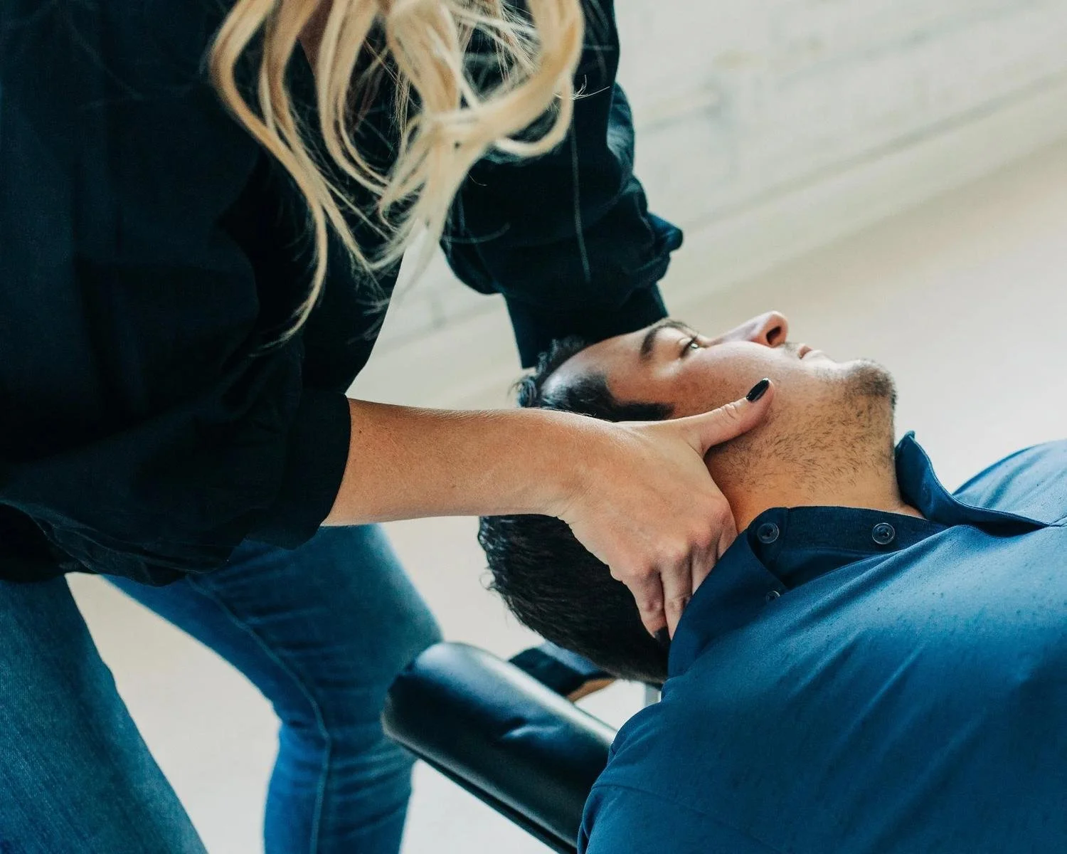 Dr. Kara Rodriguez performing an adult cervical chiropractic adjustment at Social House Chiropractic in Prosper, TX.