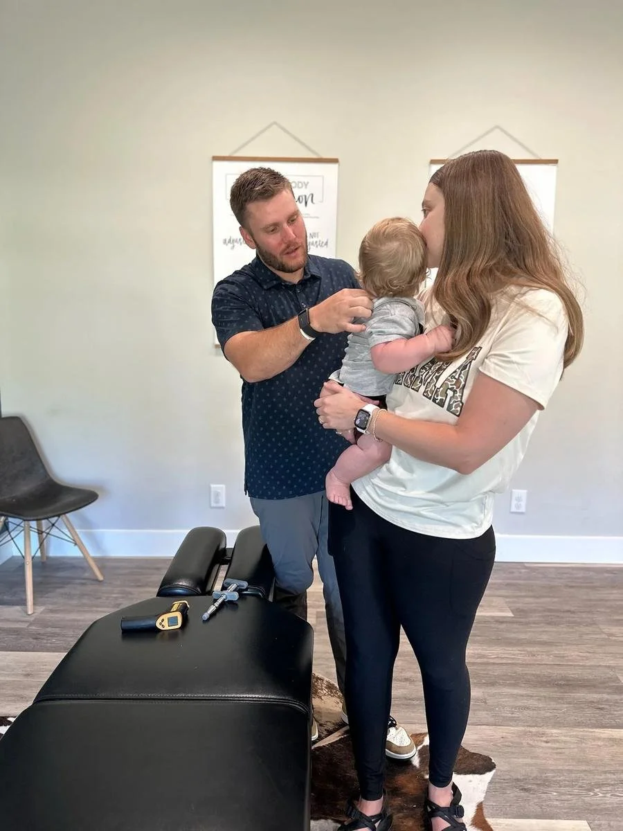 Mom and baby visit at Social House Chiropractic for chiropractic support of chronic ear infections in Prosper, TX. Drug-free, neurologically-focused care.