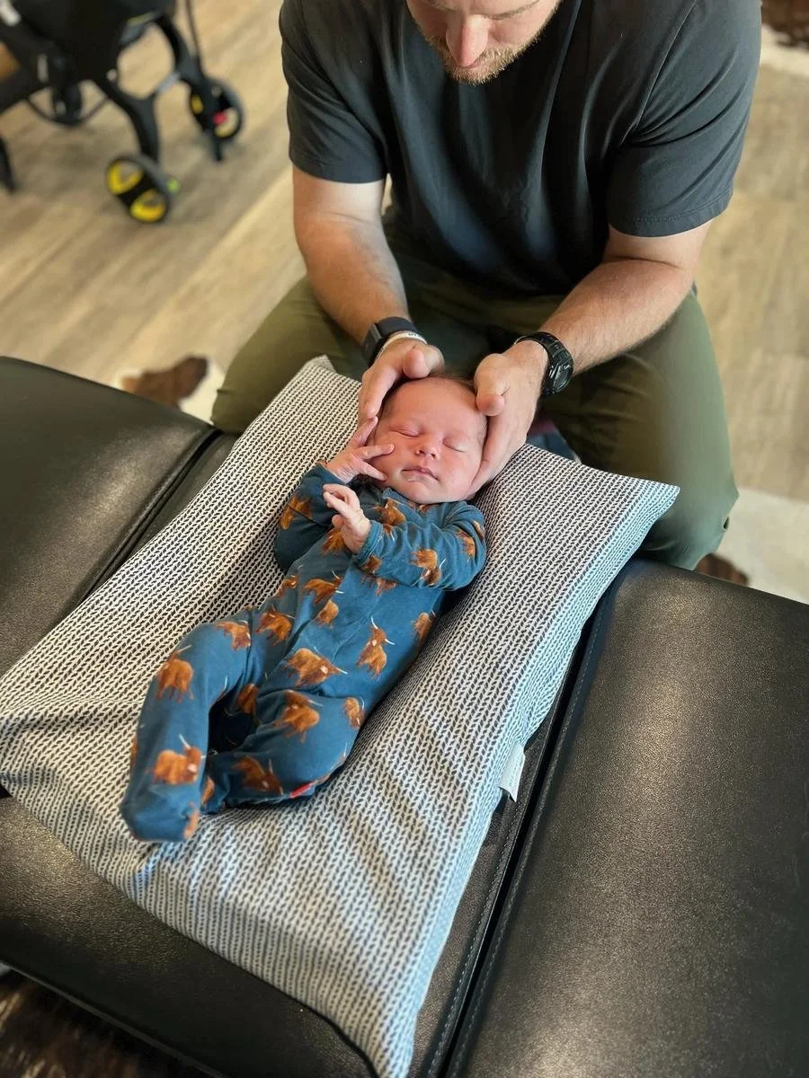 Gentle newborn chiropractic care at Social House Chiropractic in Prosper, TX. Pressure no more than checking a ripe avocado. ICPA-trained.