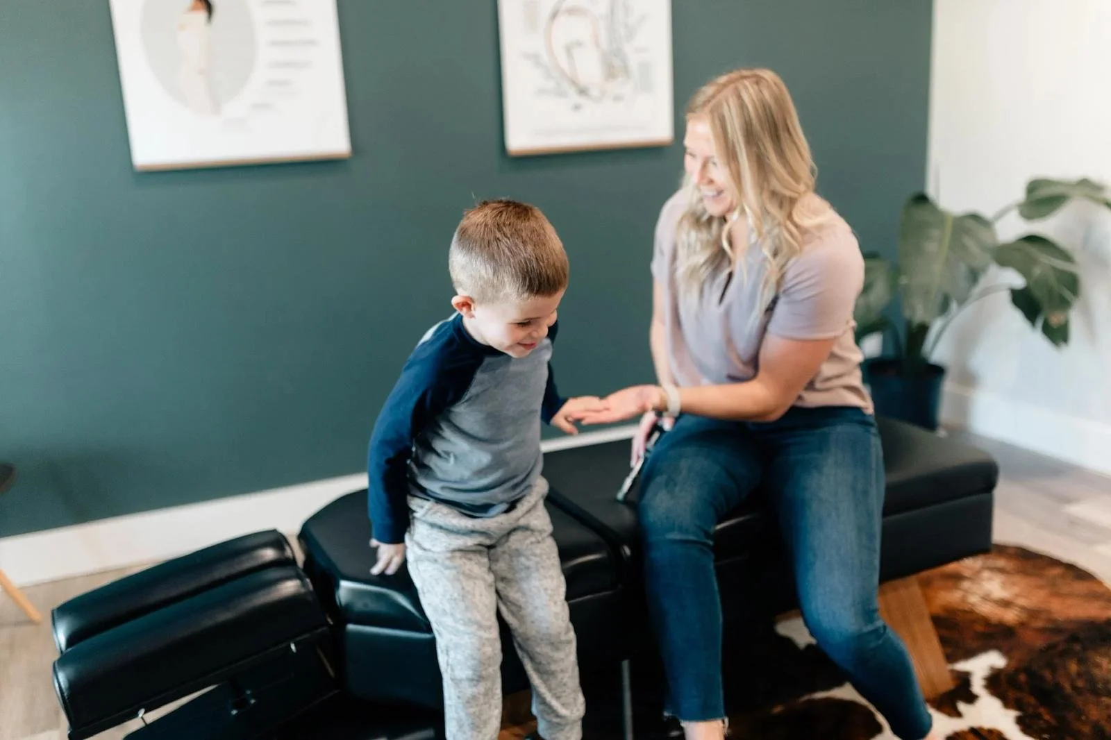 Activator instrument-assisted adjustment for school-age children at Social House Chiropractic in Prosper, TX. Gentle, low-force pediatric chiropractic care.