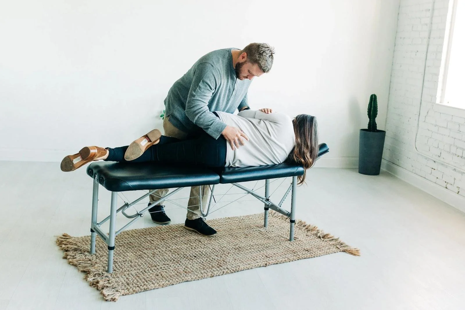 Chiropractor in Prosper, TX — Dr. Collin adjusting adult pregnant patient