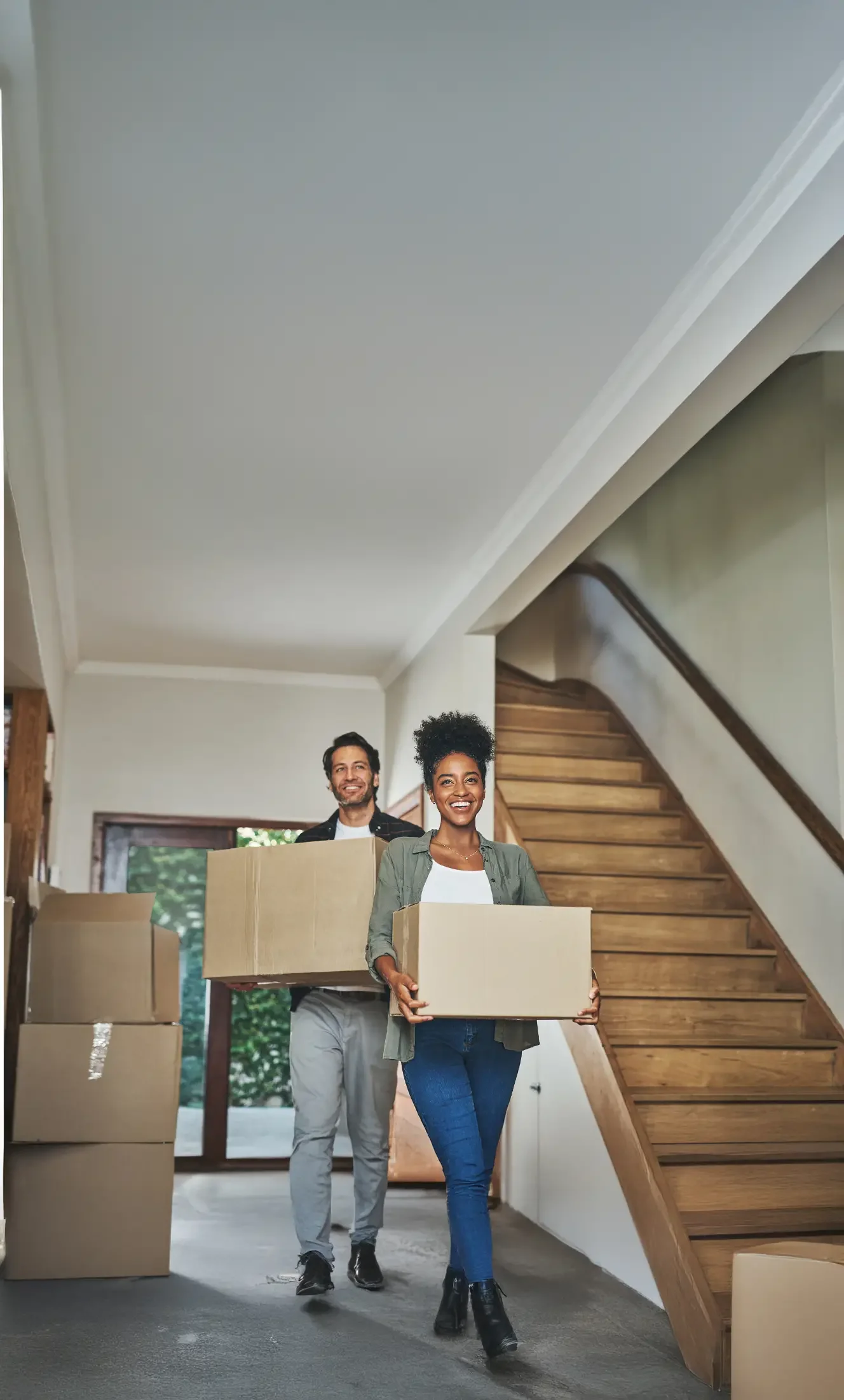 Couple moving boxes into their new home