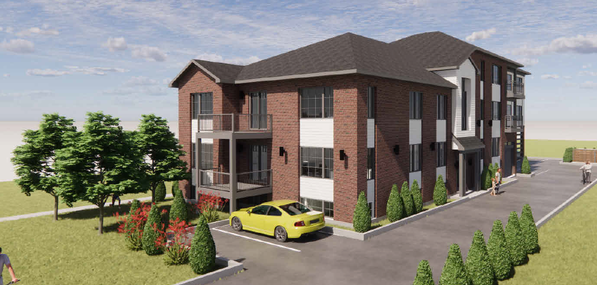 A modern four-story apartment building with red brick and white accents, surrounded by trees and shrubbery, with parking spaces and people walking outside on a sunny day.