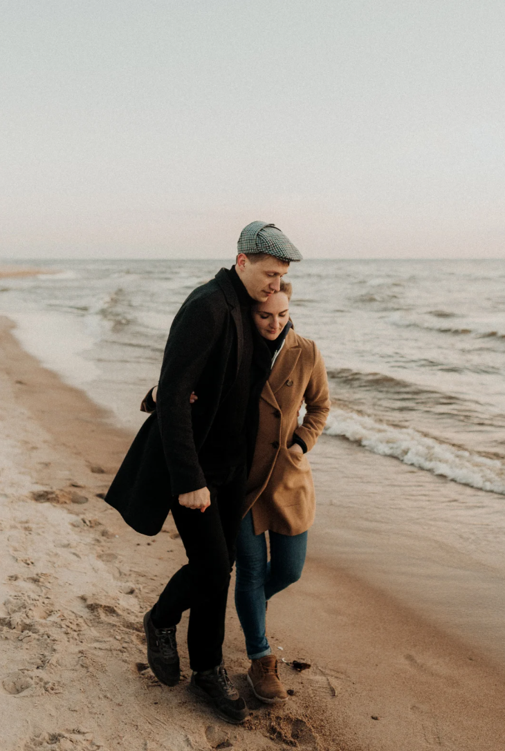 Couple walking along beach, representing relationship connection and couples therapy support