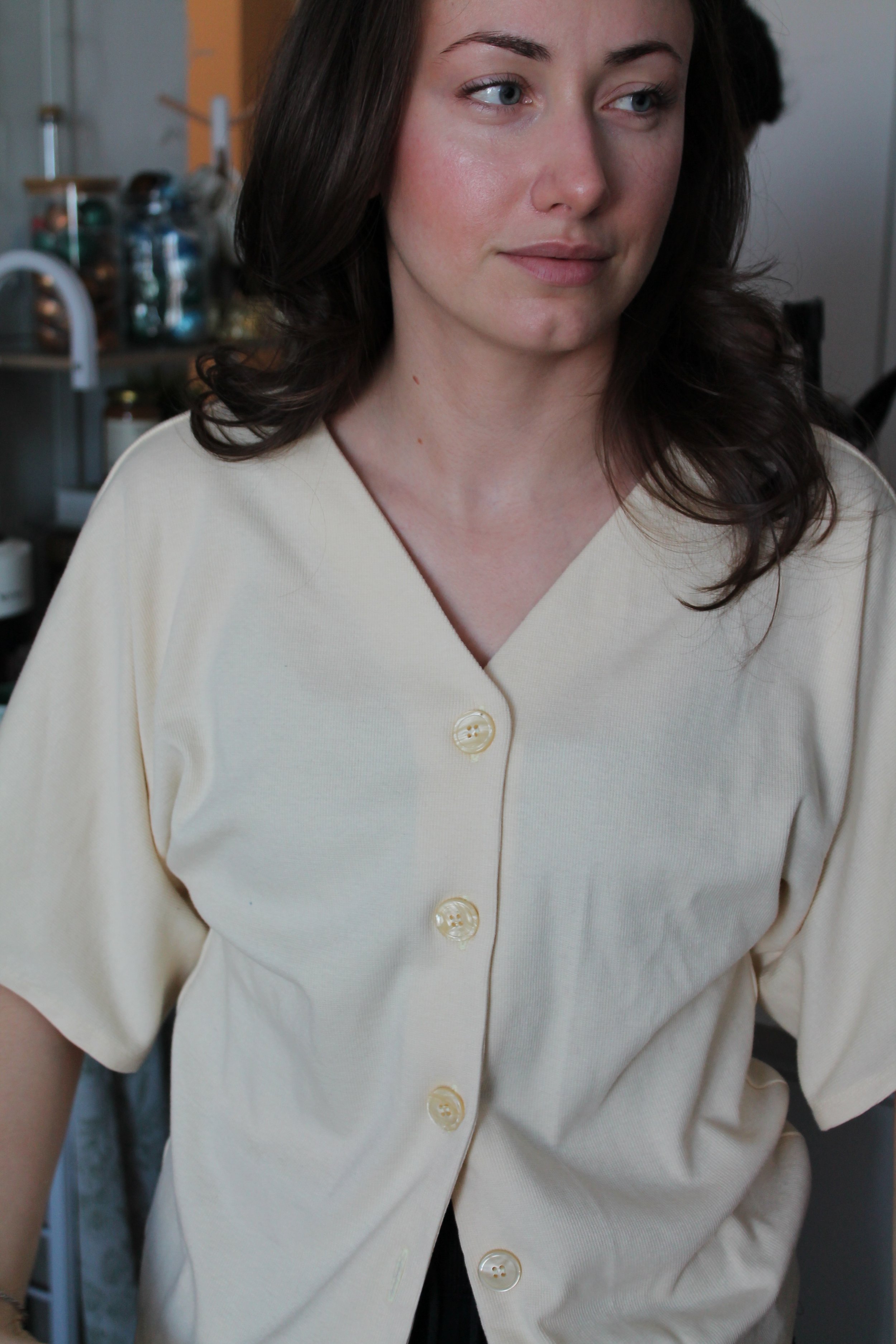 Women’s ivory V-neck blouse with a relaxed fit and soft, flowy silhouette