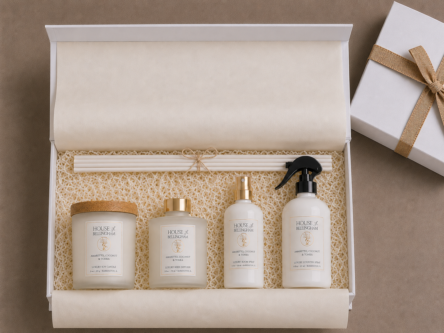 Open white gift box featuring The Layering Collection from House of Bellingham with a luxury soy candle, reed diffuser, room spray, countertop spray, diffuser reeds, and a ribboned gift box.