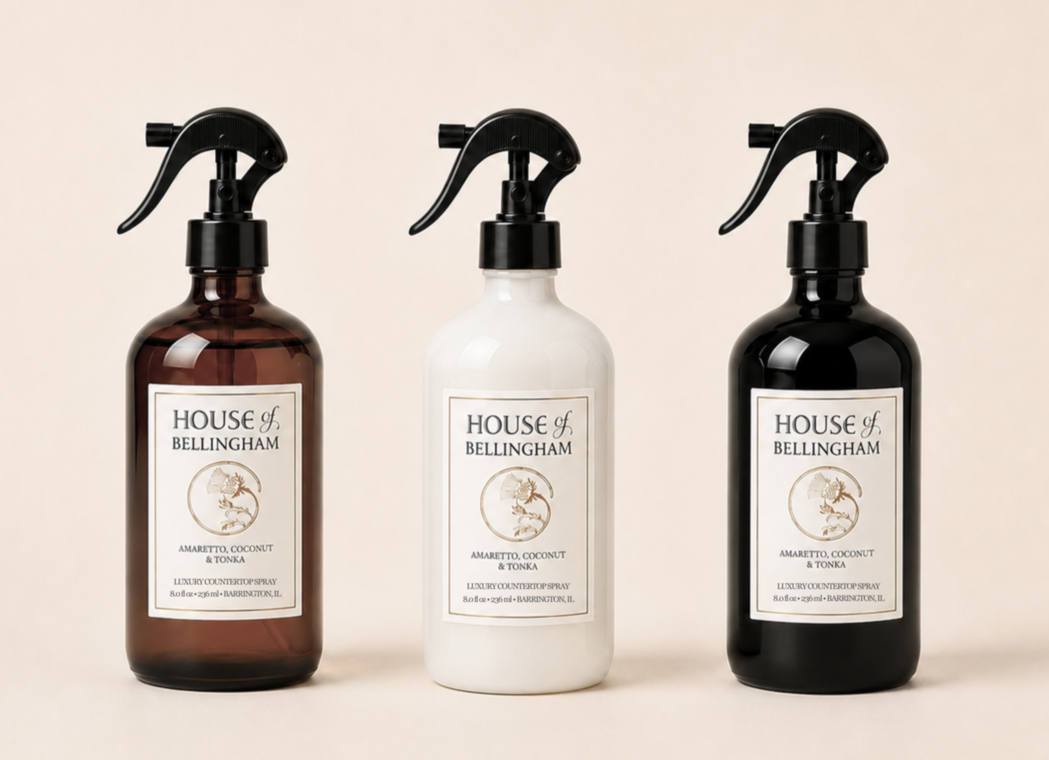 Three House of Bellingham countertop sprays in amber, white, and black finishes with black trigger sprayers.