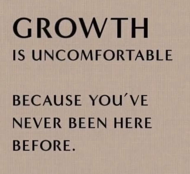 An inspirational quote on a wall that reads, 'Growth is uncomfortable because you've never been here before' in black text on a light background.