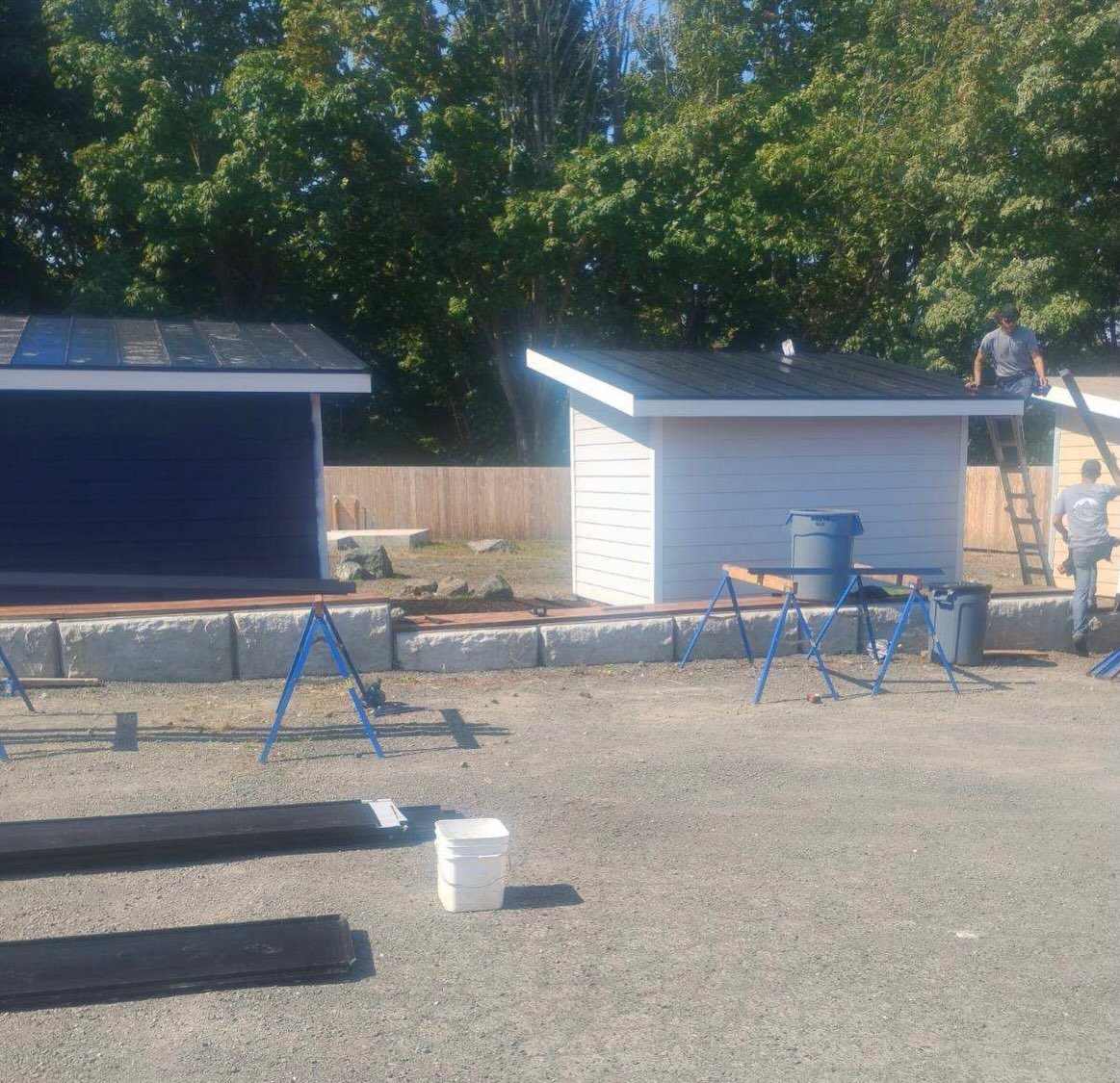 We had to wait until Wednesday to post the TINY HOME TUESDAY update because all the action started today! 

First up, Fred Patton and Olympic Sheet Metal installing new metal roofs on our next three tiny homes with material that they generously donat