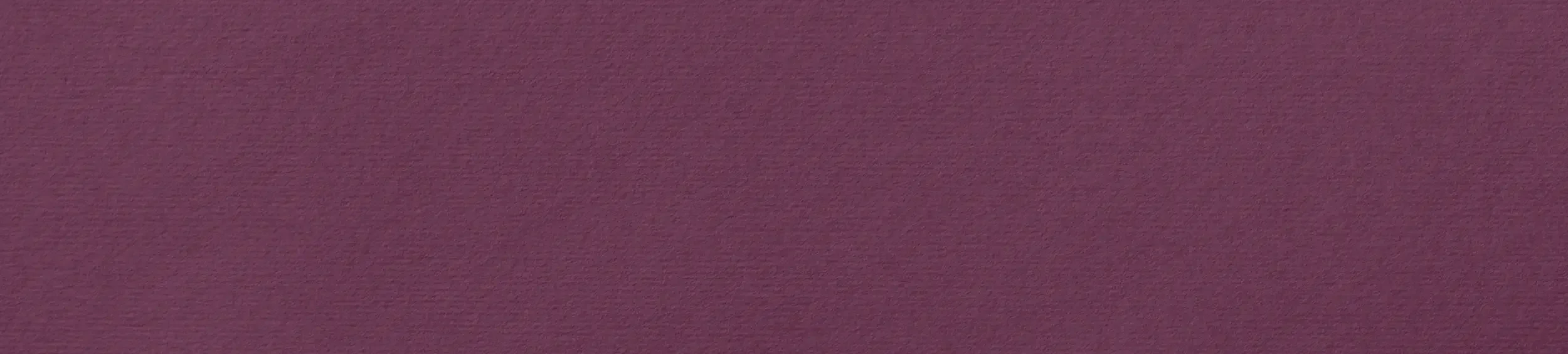 A close-up of a textured surface with a purple hue.