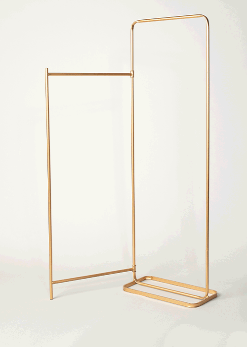 A modern, minimalistic gold clothing rack with a rectangular base and a large, upright frame.
